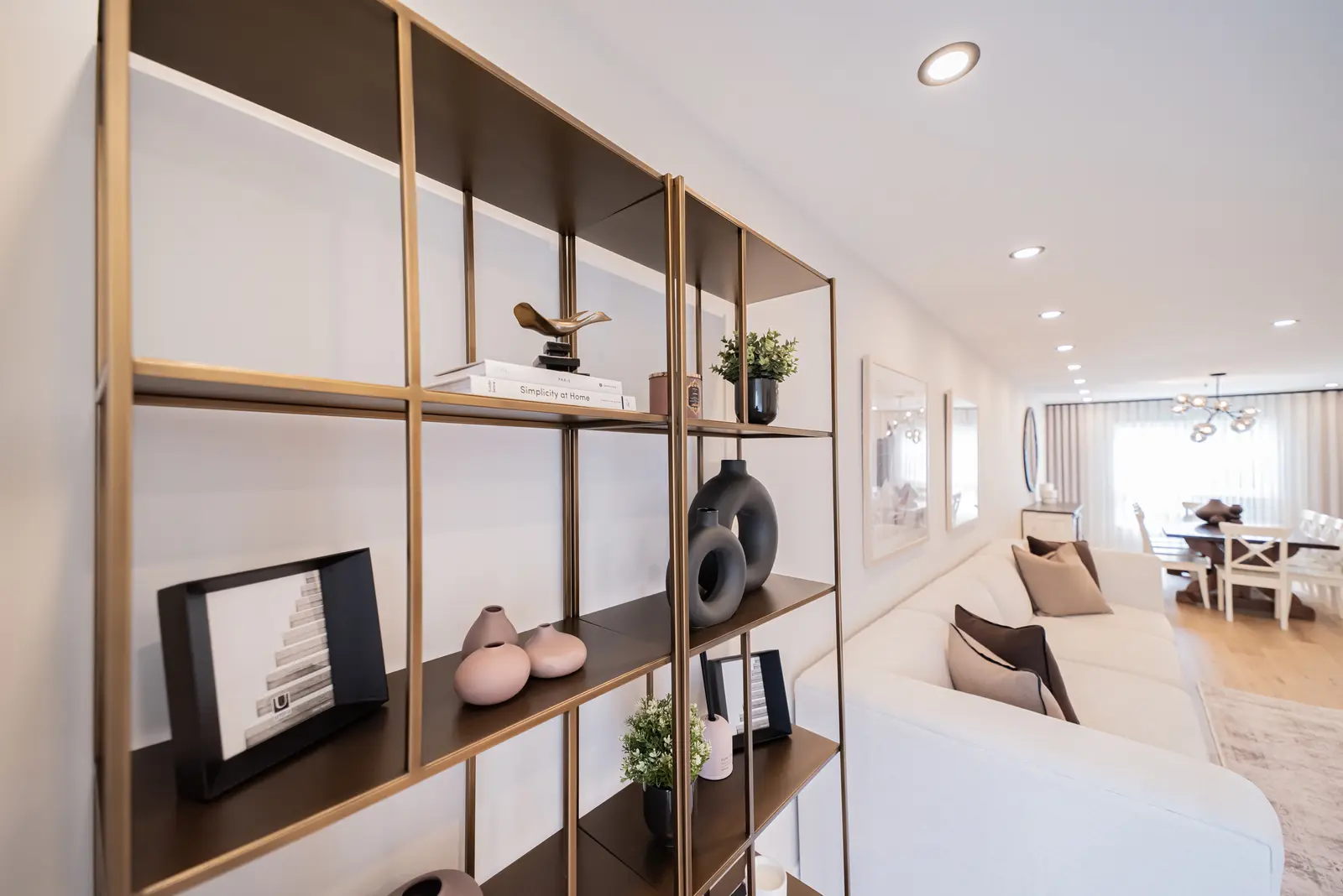 Interior of a Thornhill house renovation, with sage cabinetry, light wood floors, walnut, and brass fittings.