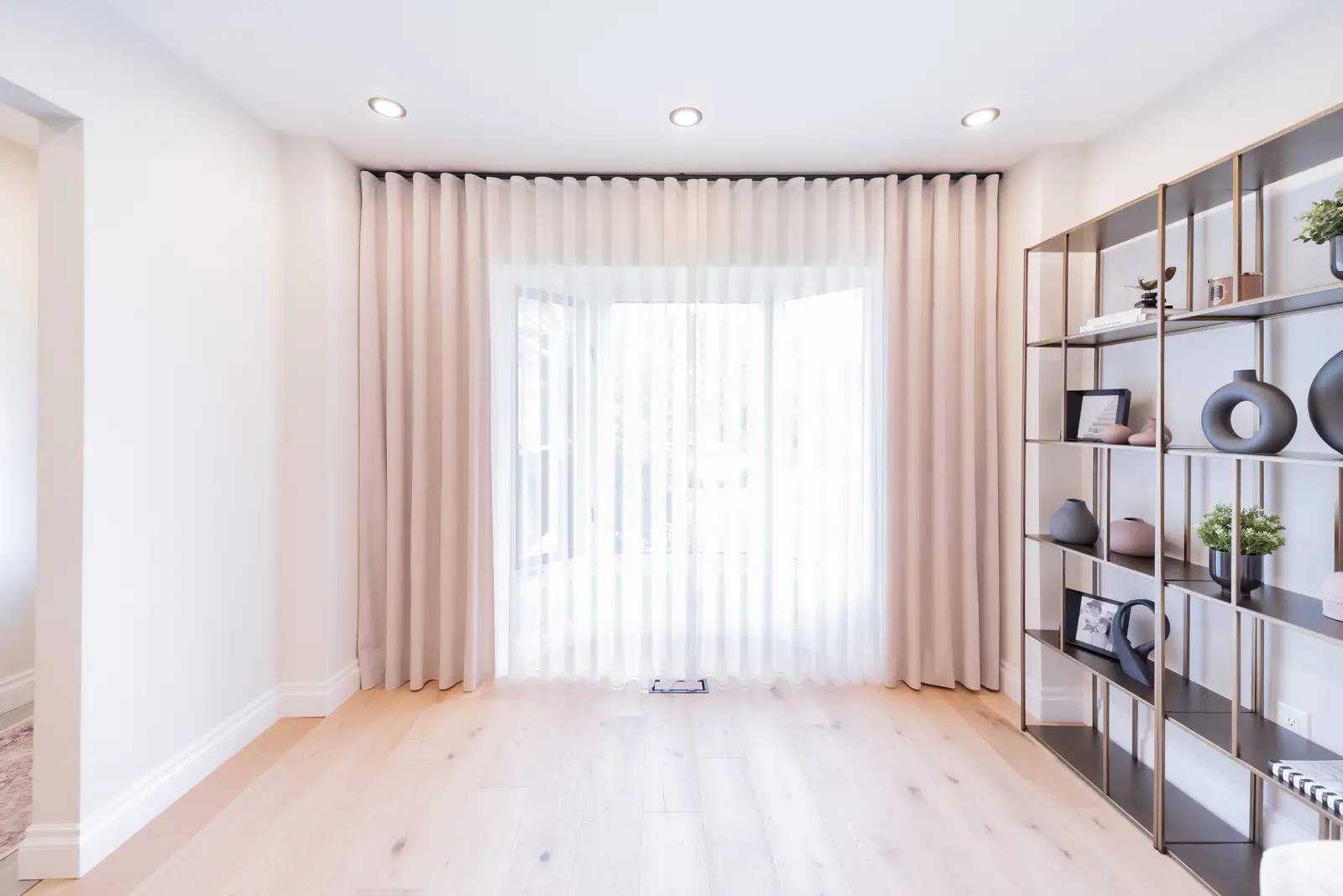 Interior of a Thornhill house renovation, with sage cabinetry, light wood floors, walnut, and brass fittings.