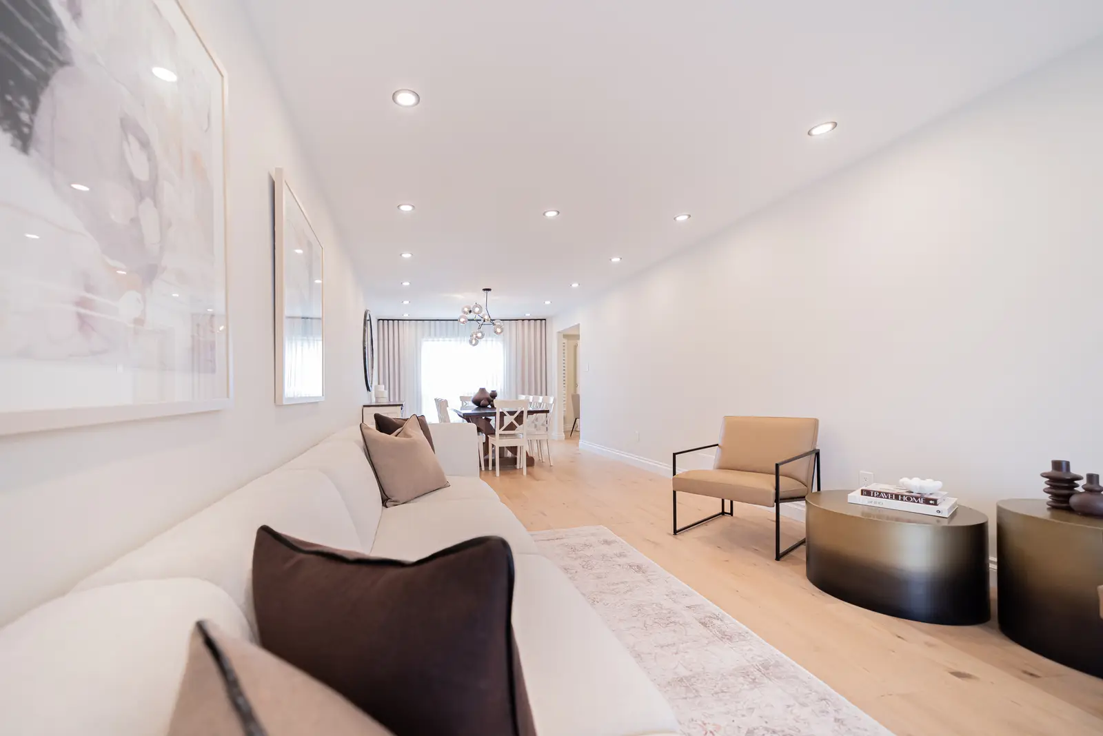 Interior of a Thornhill house renovation, with sage cabinetry, light wood floors, walnut, and brass fittings.