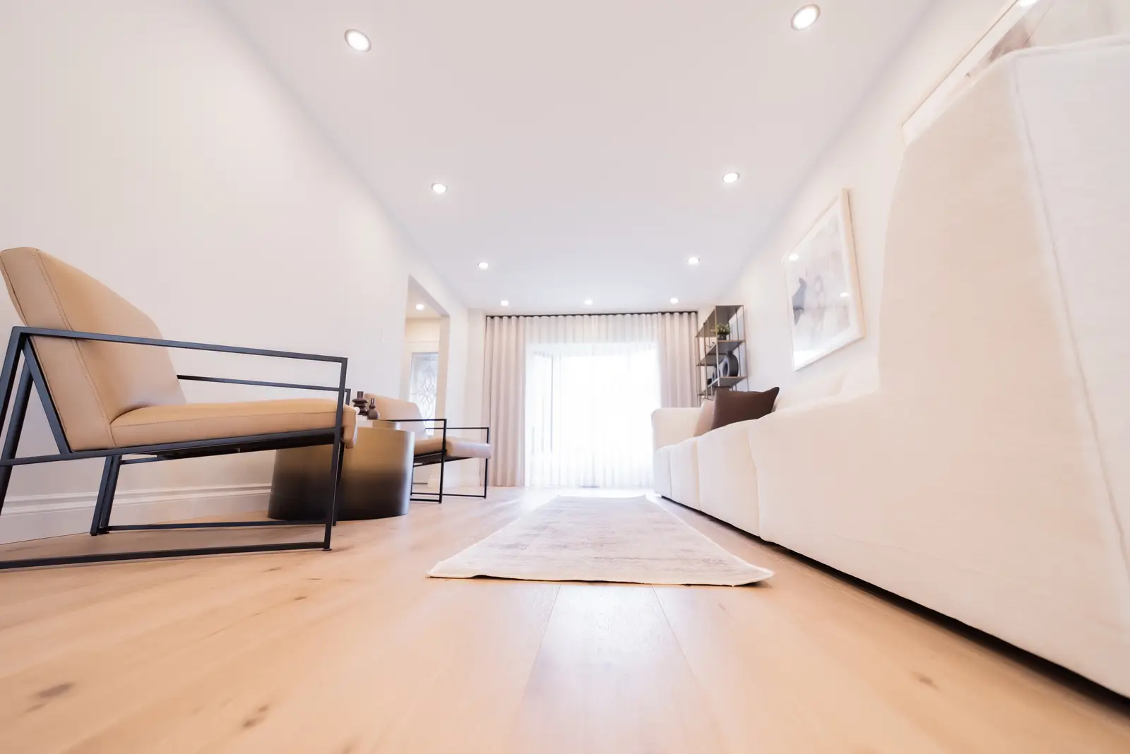 Interior of a Thornhill house renovation, with sage cabinetry, light wood floors, walnut, and brass fittings.