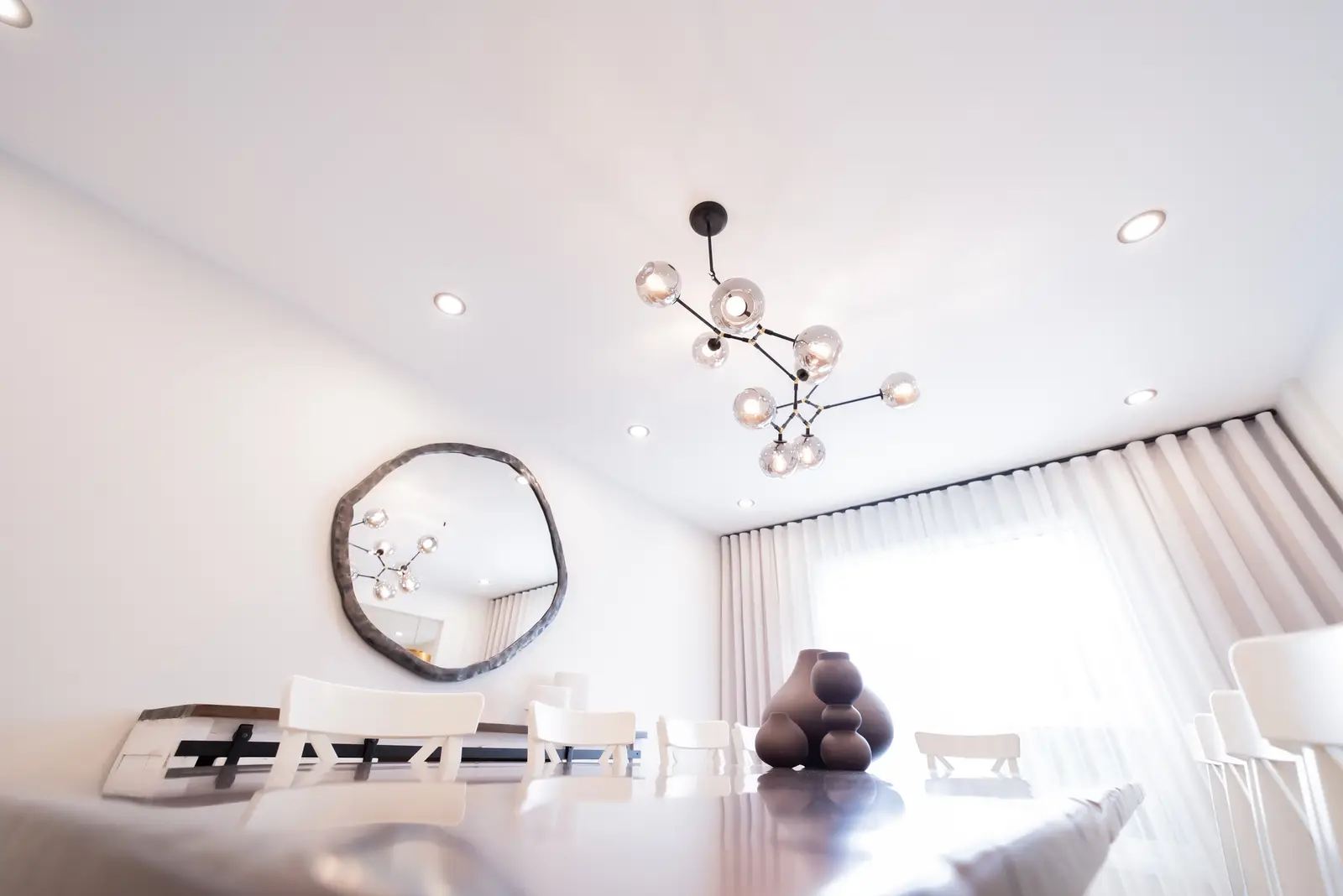 Interior of a Thornhill house renovation, with sage cabinetry, light wood floors, walnut, and brass fittings.
