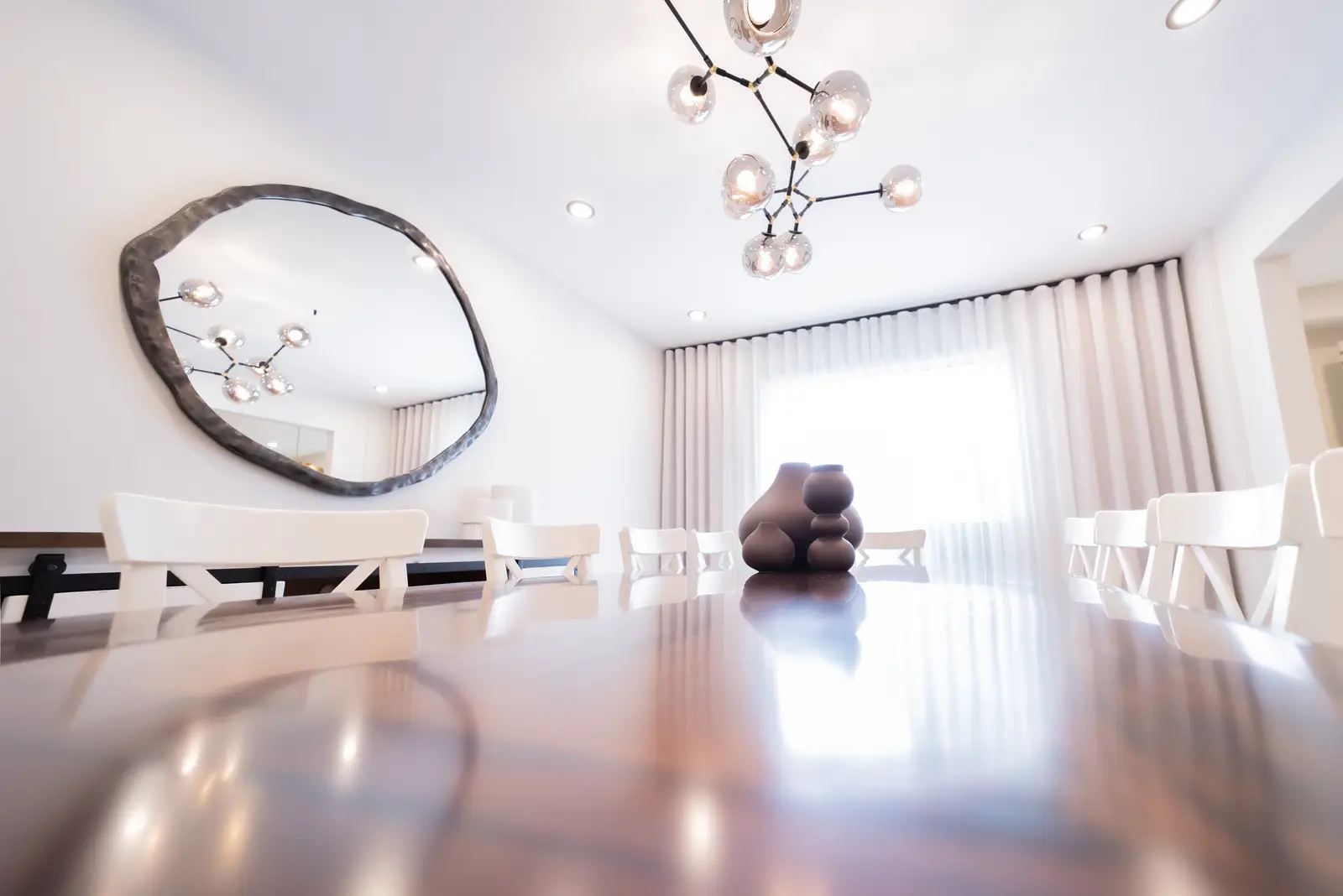 Interior of a Thornhill house renovation, with sage cabinetry, light wood floors, walnut, and brass fittings.