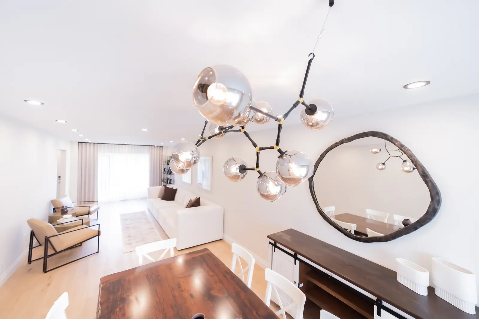 Interior of a Thornhill house renovation, with sage cabinetry, light wood floors, walnut, and brass fittings.