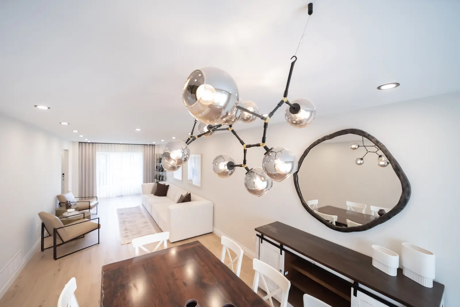 Interior of a Thornhill house renovation, with sage cabinetry, light wood floors, walnut, and brass fittings.