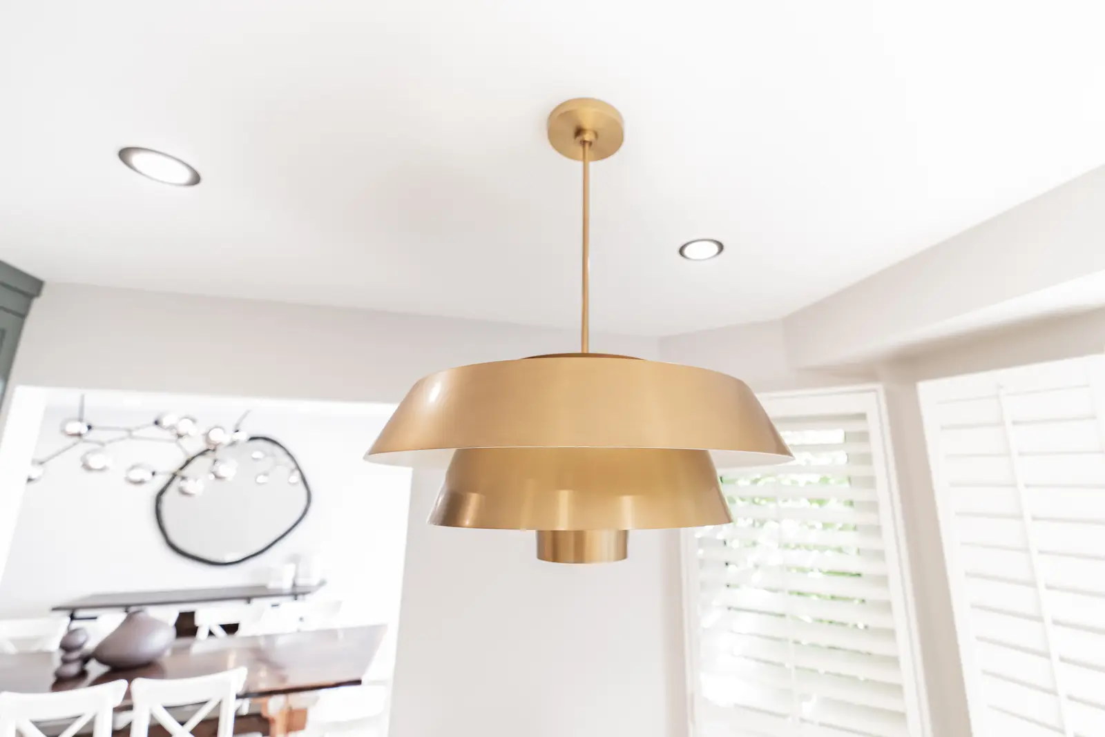 Interior of a Thornhill house renovation, with sage cabinetry, light wood floors, walnut, and brass fittings.