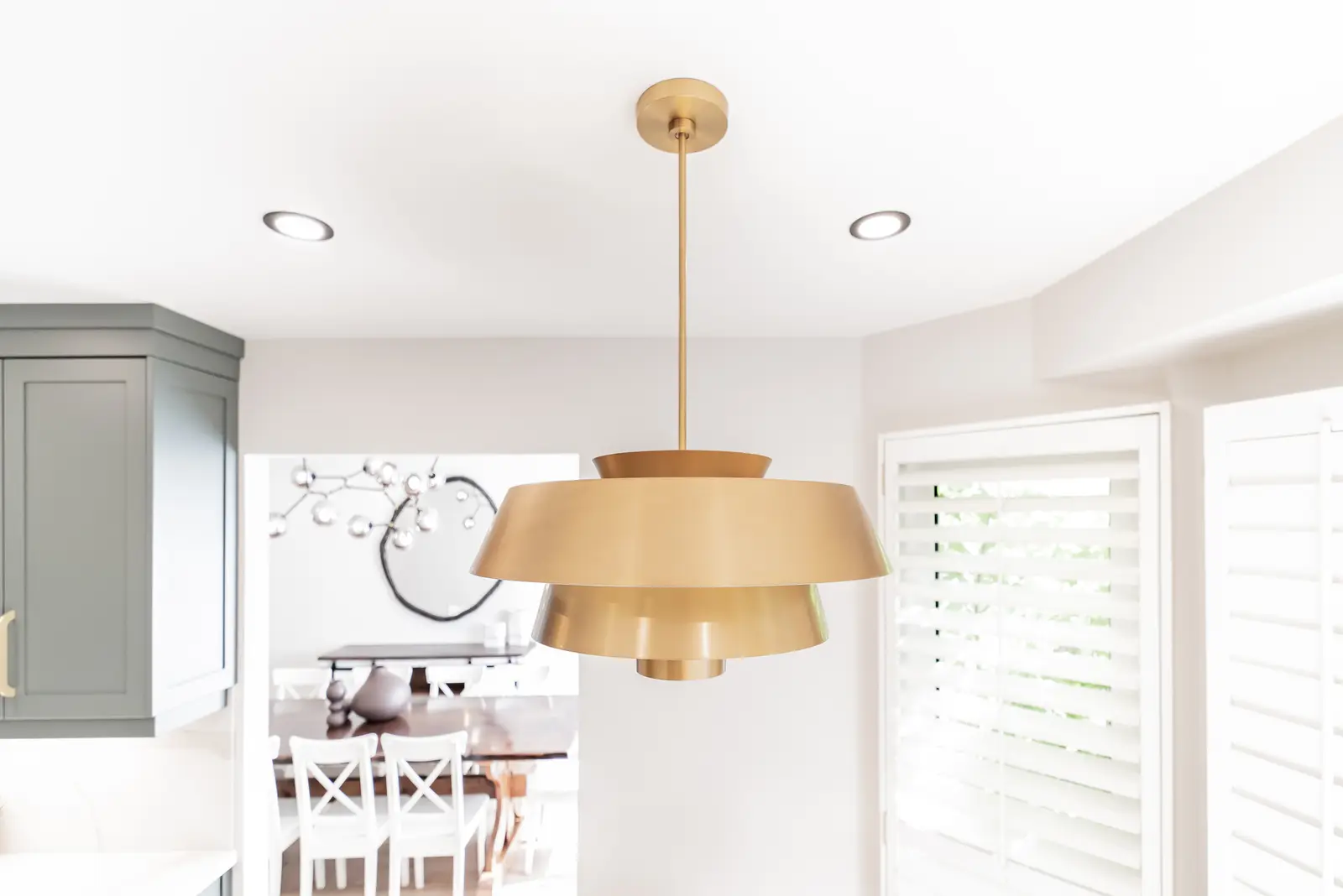 Interior of a Thornhill house renovation, with sage cabinetry, light wood floors, walnut, and brass fittings.