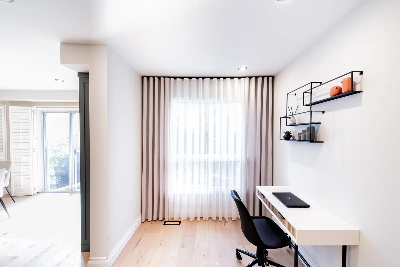 Interior of a Thornhill house renovation, with sage cabinetry, light wood floors, walnut, and brass fittings.