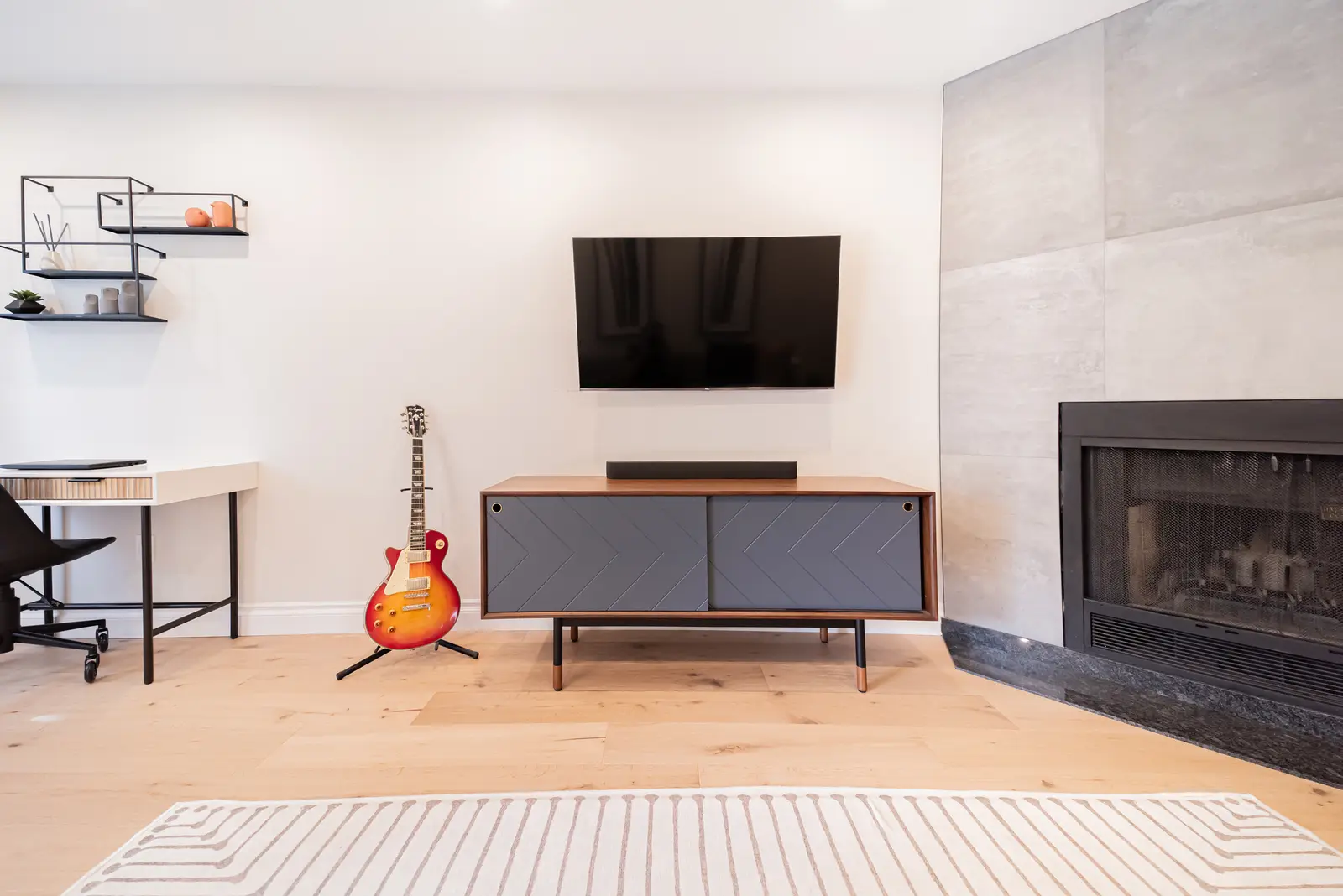 Interior of a Thornhill house renovation, with sage cabinetry, light wood floors, walnut, and brass fittings.