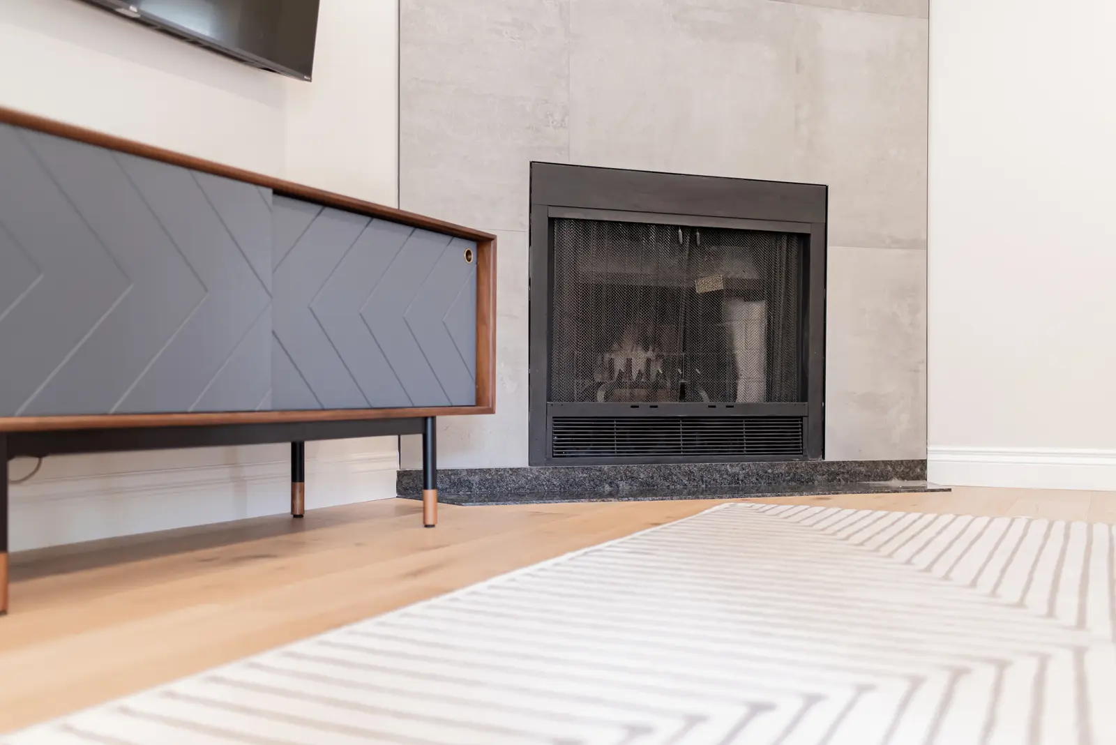 Interior of a Thornhill house renovation, with sage cabinetry, light wood floors, walnut, and brass fittings.