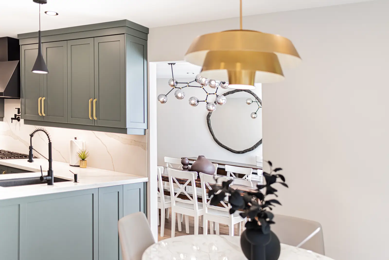 Interior of a Thornhill house renovation, with sage cabinetry, light wood floors, walnut, and brass fittings.