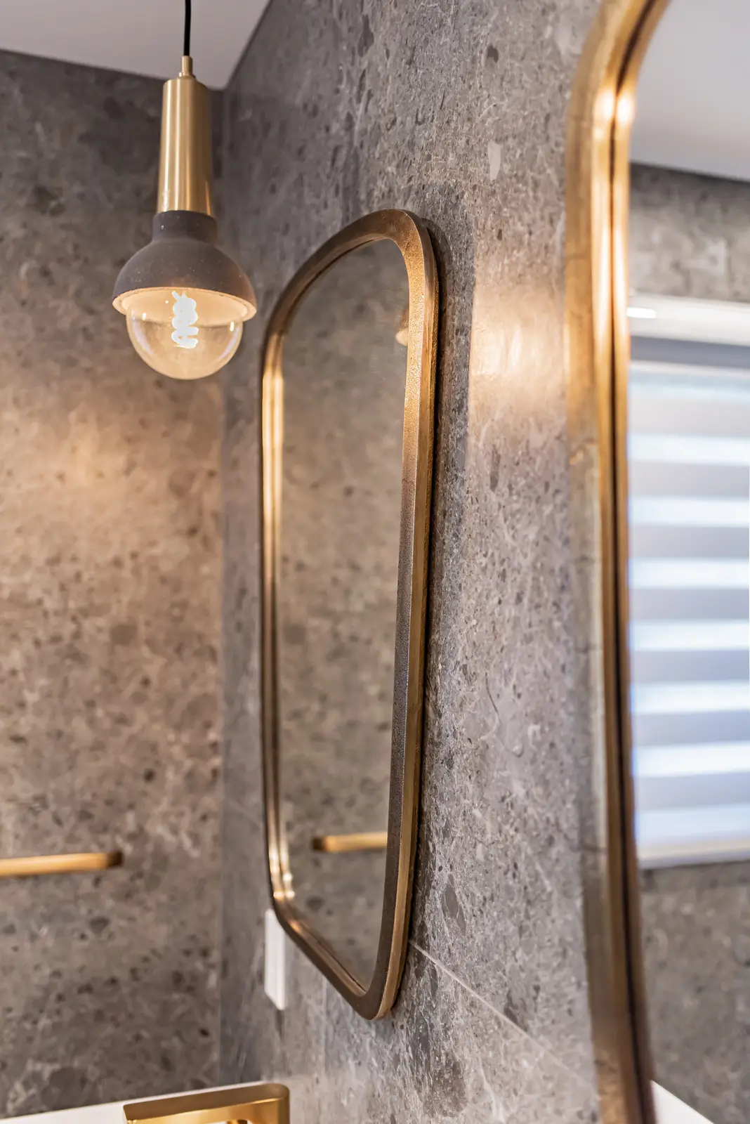 Interior of a Thornhill house renovation, with sage cabinetry, light wood floors, walnut, and brass fittings.