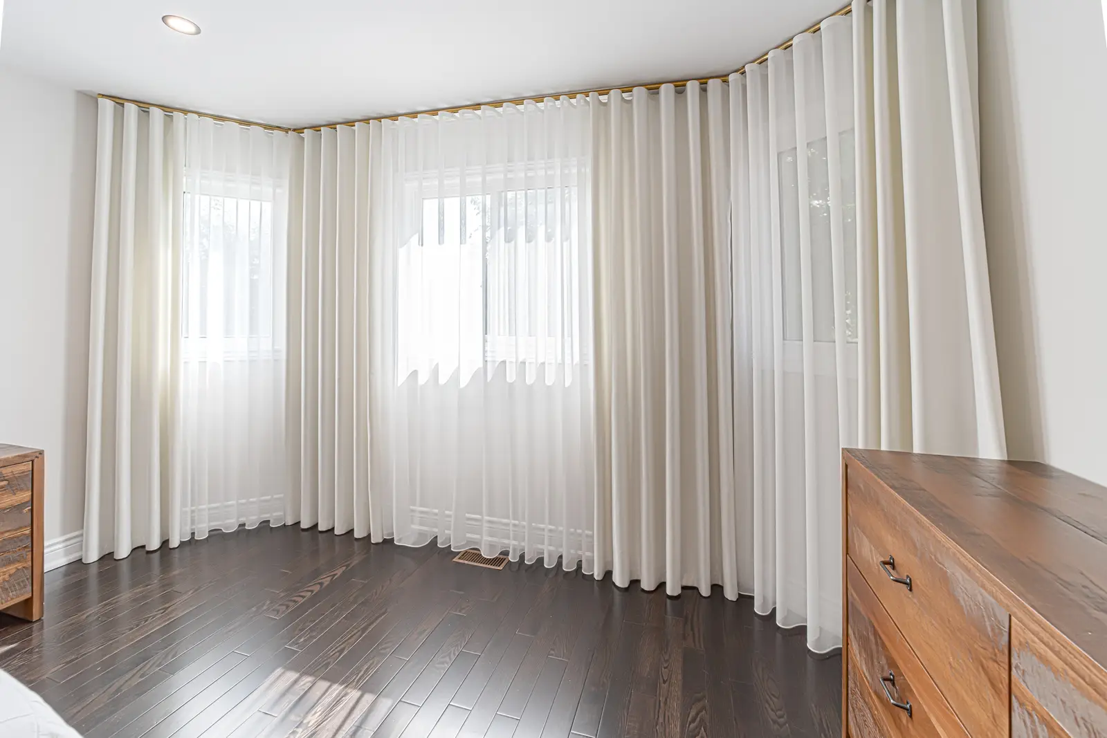 Interior of a Thornhill house renovation, with sage cabinetry, light wood floors, walnut, and brass fittings.