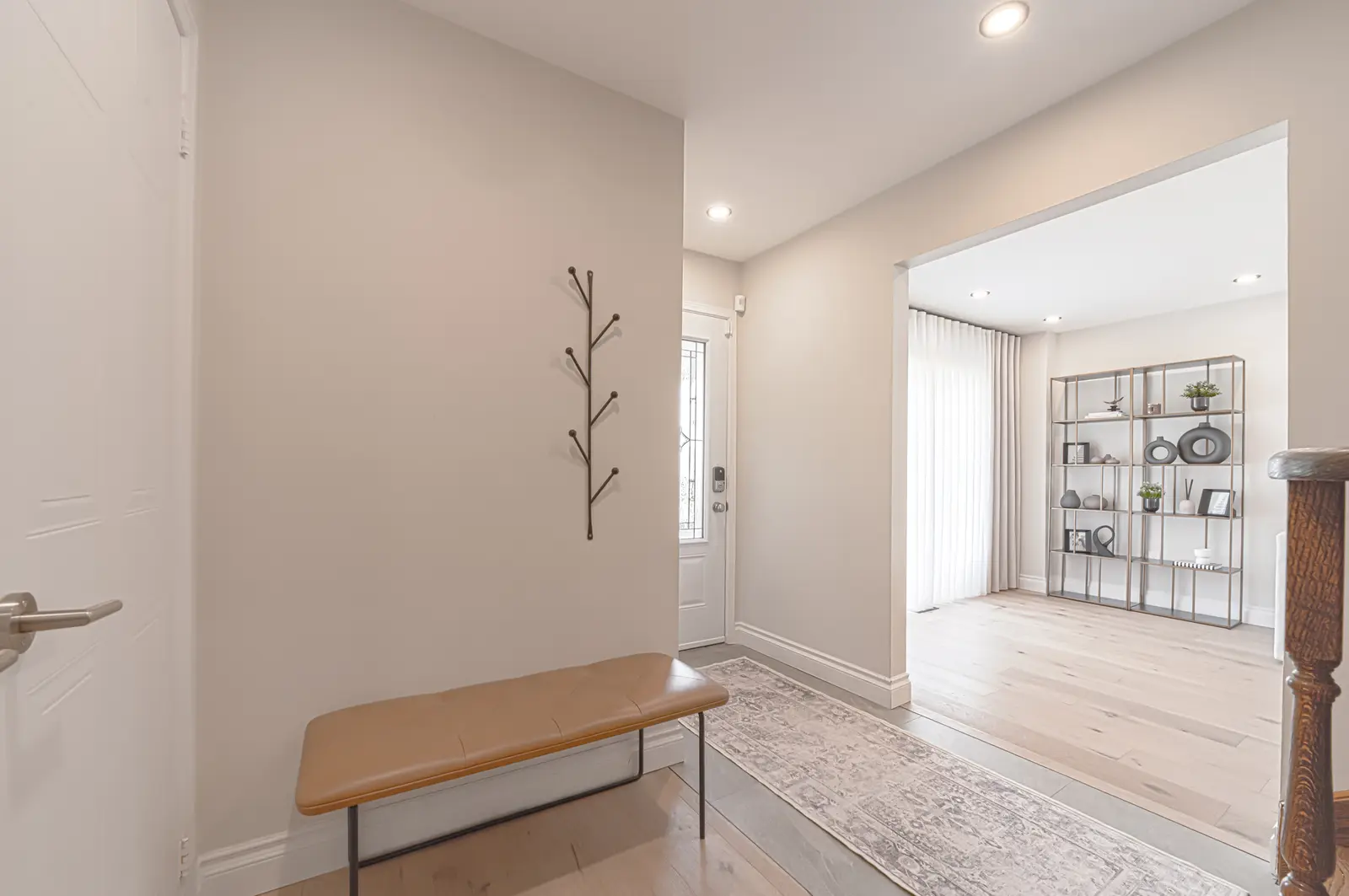 Interior of a Thornhill house renovation, with sage cabinetry, light wood floors, walnut, and brass fittings.