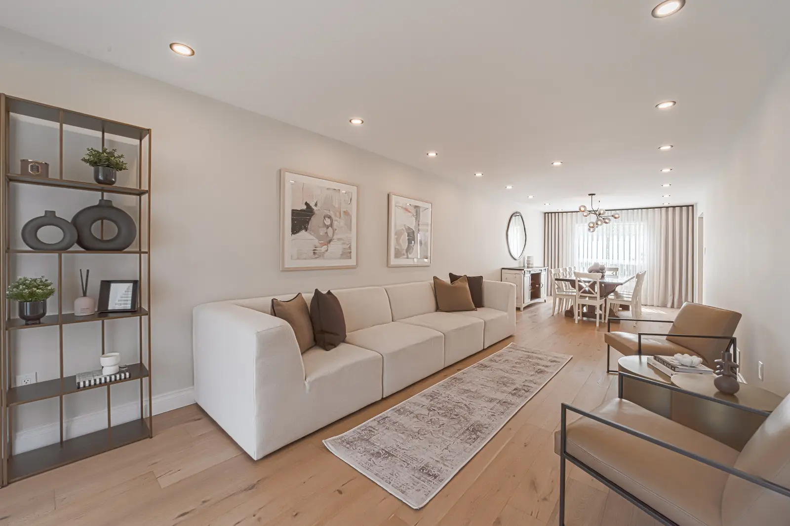 Interior of a Thornhill house renovation, with sage cabinetry, light wood floors, walnut, and brass fittings.