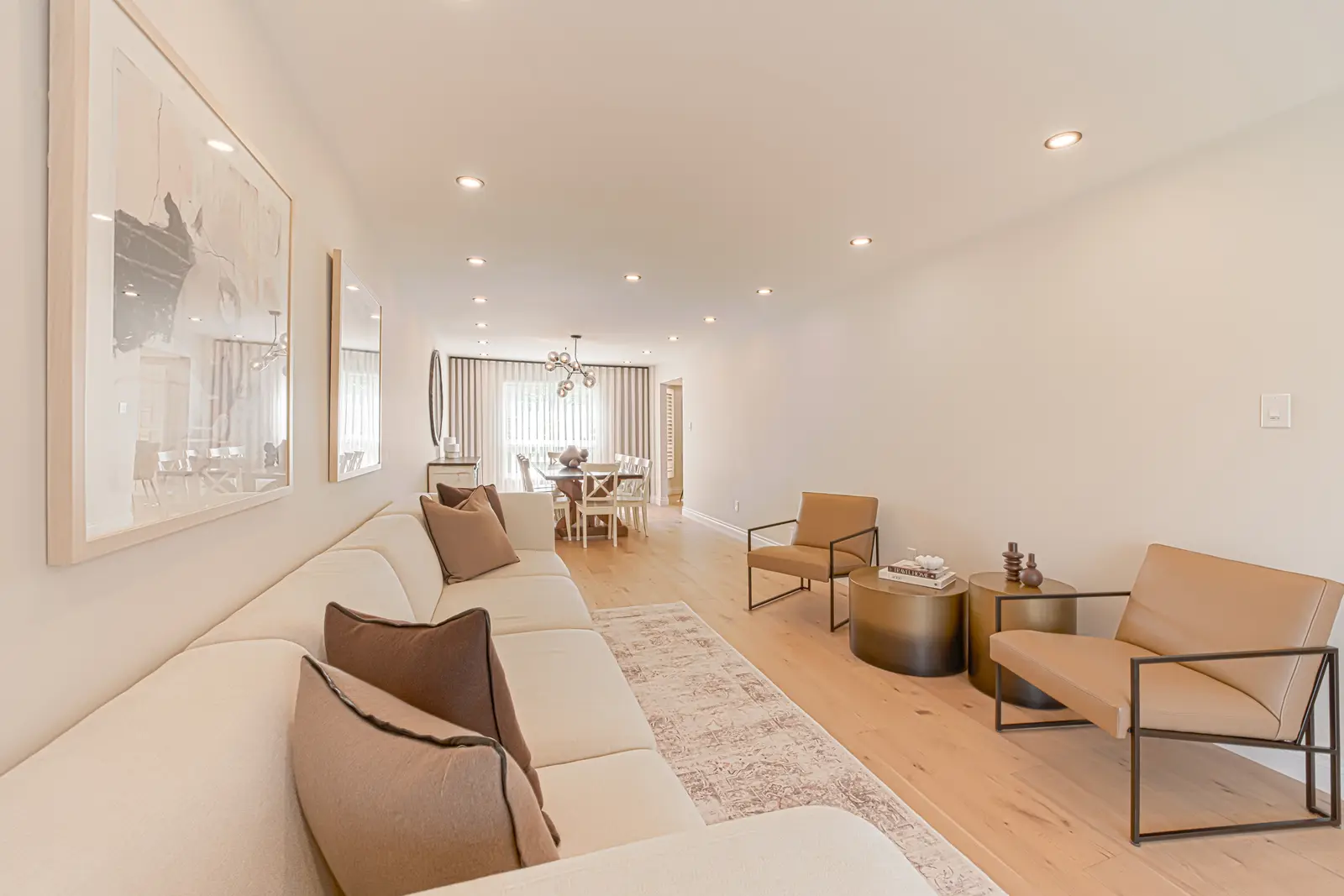 Interior of a Thornhill house renovation, with sage cabinetry, light wood floors, walnut, and brass fittings.