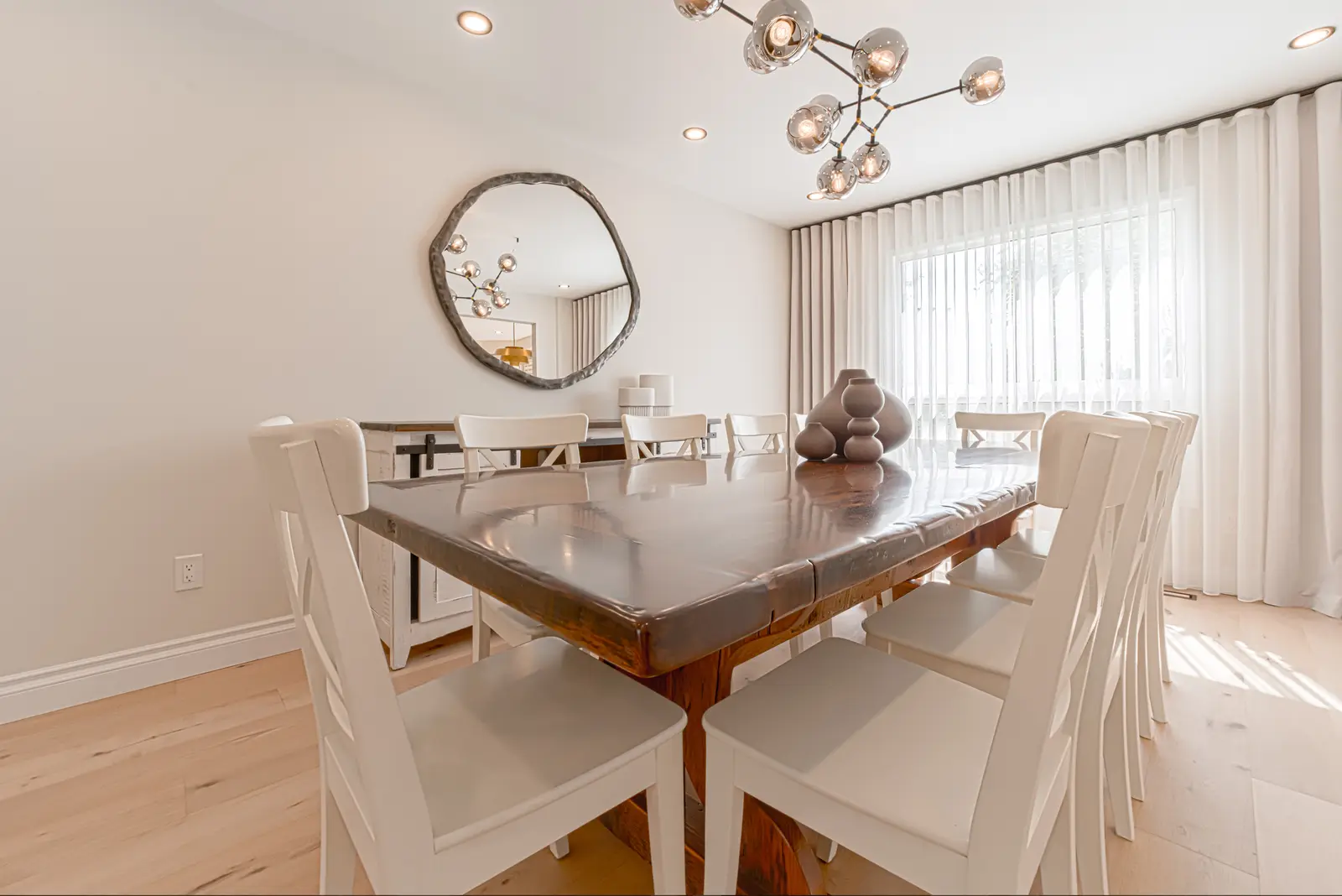 Interior of a Thornhill house renovation, with sage cabinetry, light wood floors, walnut, and brass fittings.