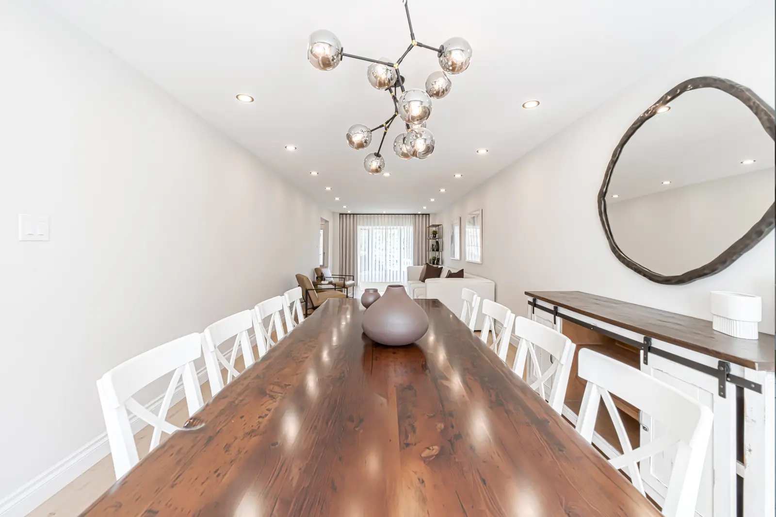 Interior of a Thornhill house renovation, with sage cabinetry, light wood floors, walnut, and brass fittings.