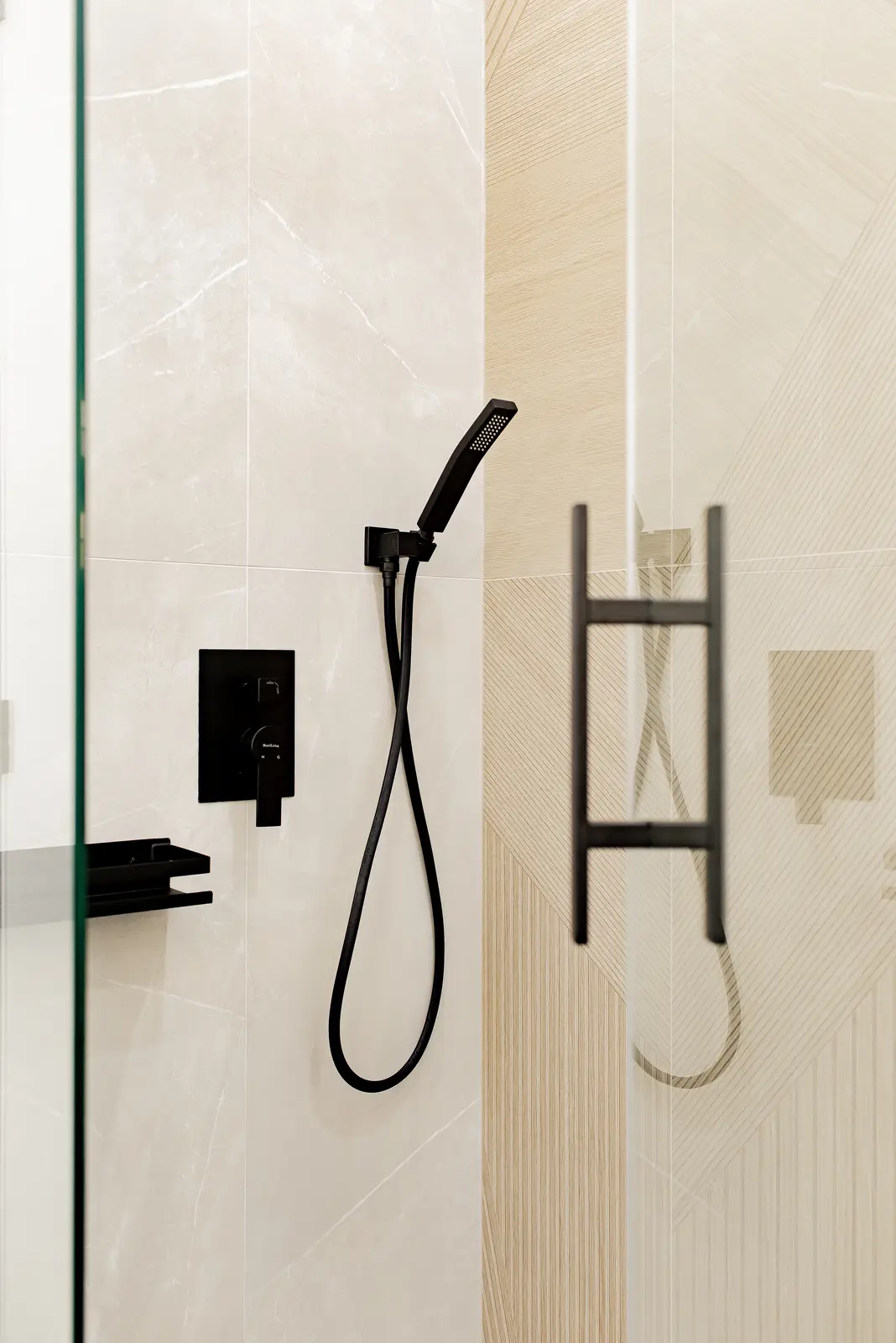 Interior of a Thornhill house renovation, with pale walls, a veined stone kitchen, light wood floors, and black fittings.