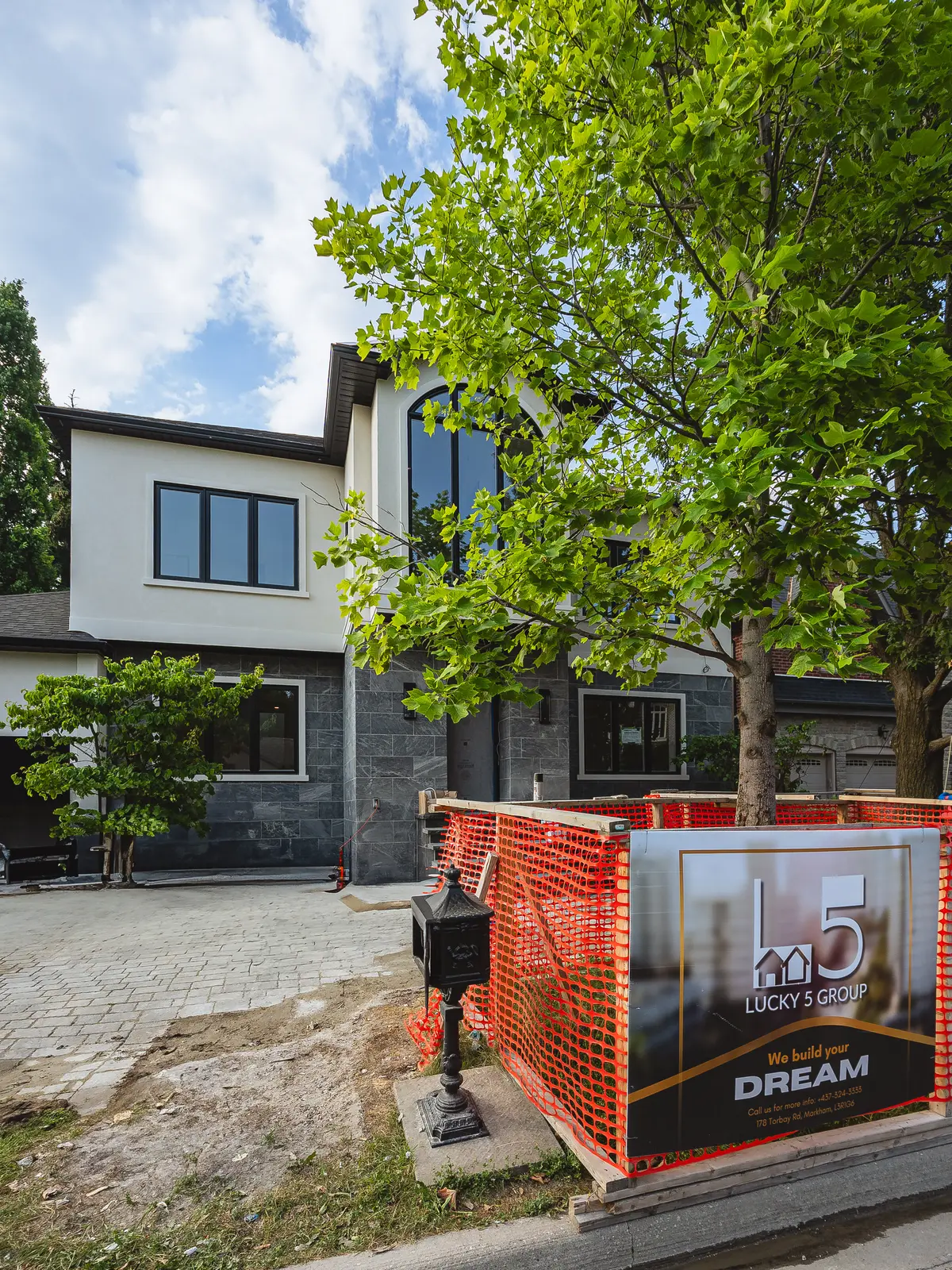 Room in a North York detached house renovation, with pale oak floors, white walls, and marble or warm wood millwork.