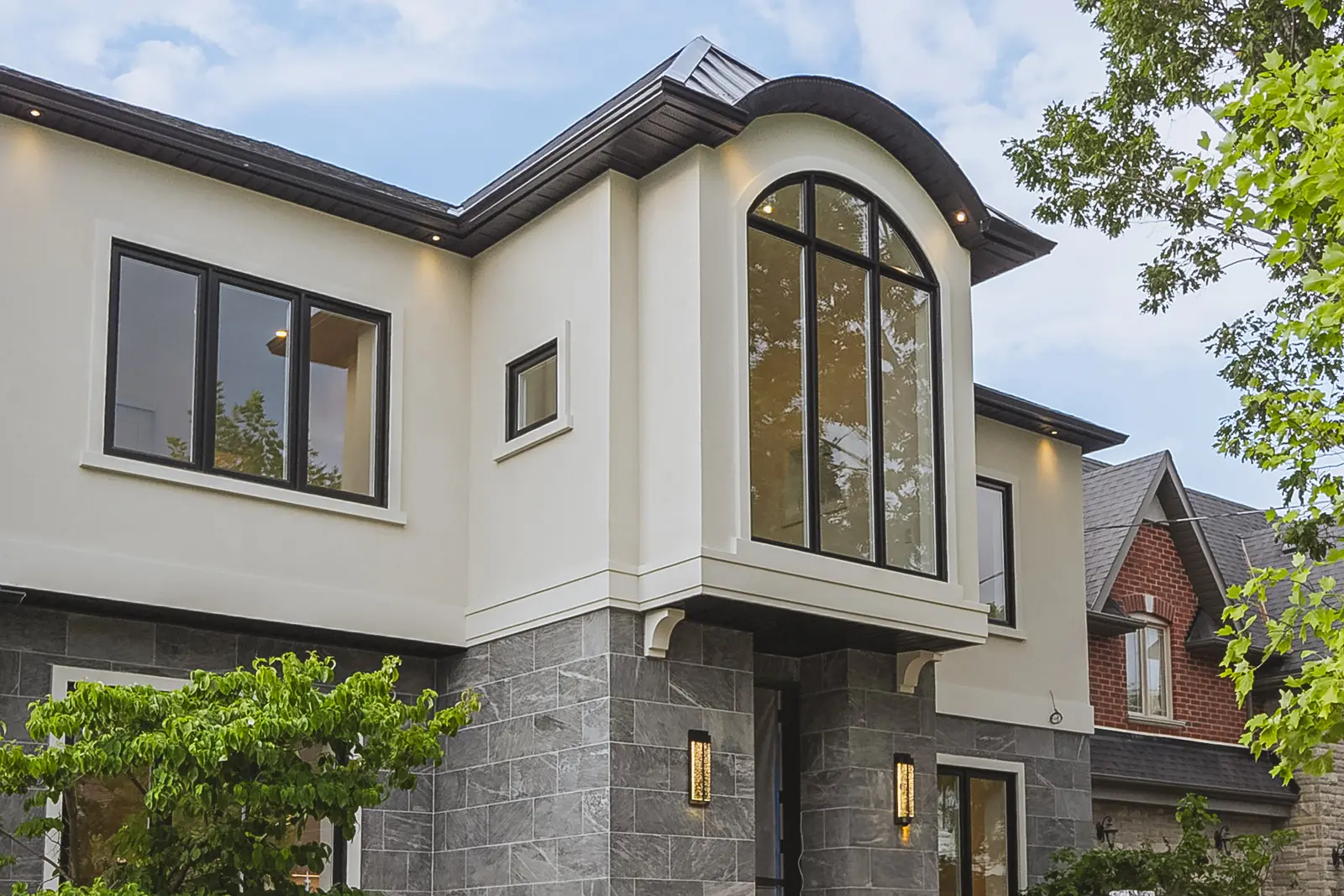 Room in a North York detached house renovation, with pale oak floors, white walls, and marble or warm wood millwork.