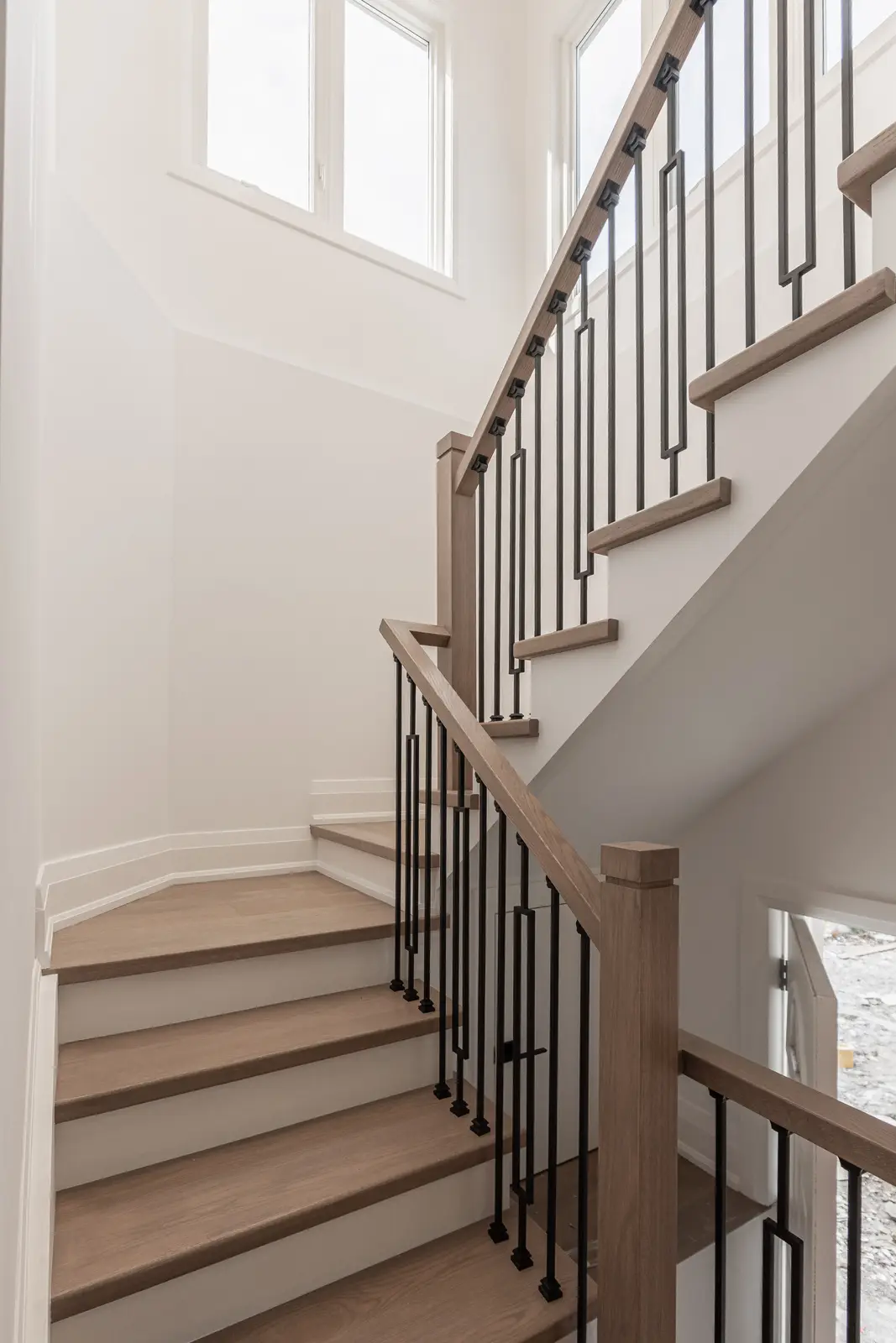 Room in a North York detached house renovation, with pale oak floors, white walls, and marble or warm wood millwork.