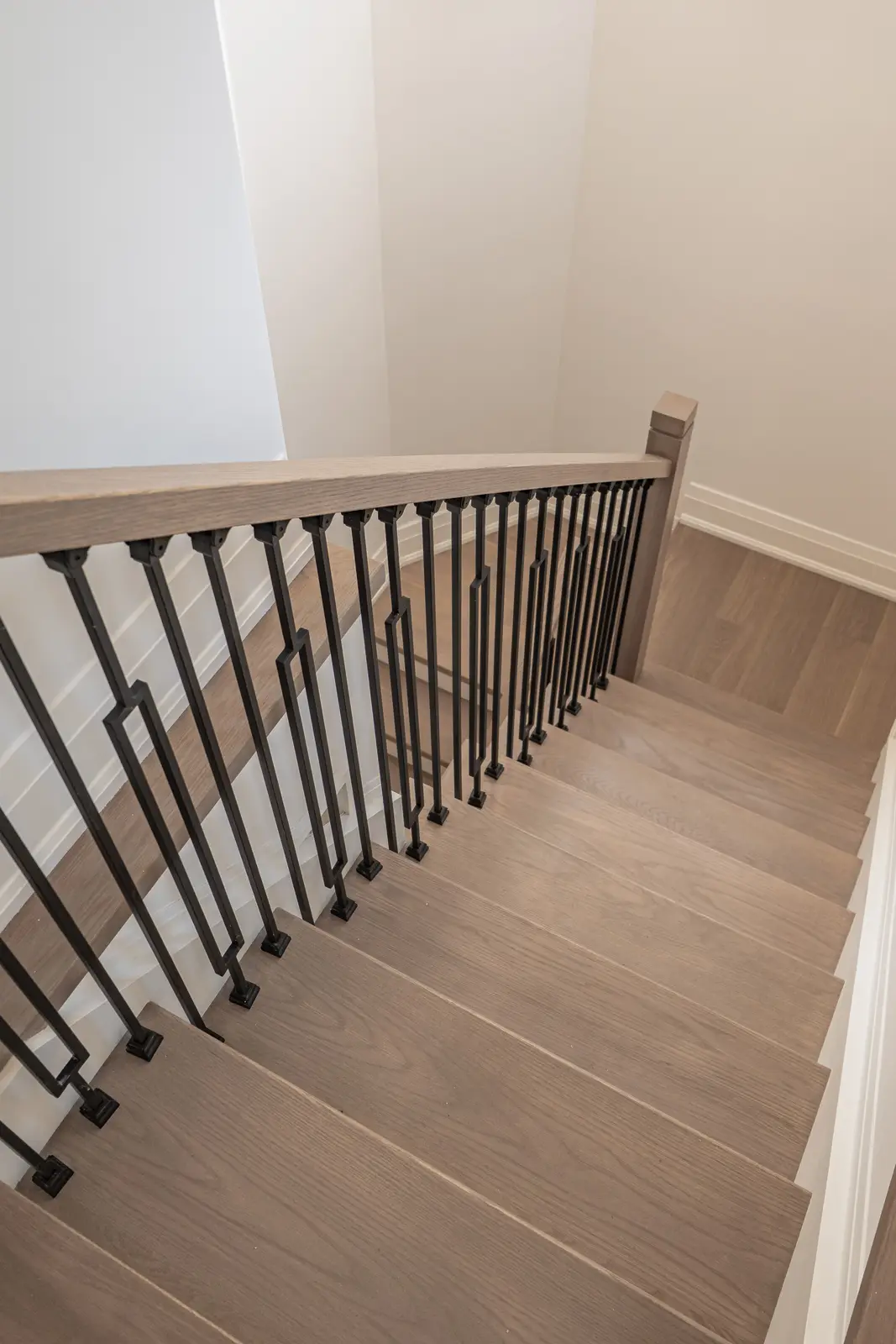 Room in a North York detached house renovation, with pale oak floors, white walls, and marble or warm wood millwork.