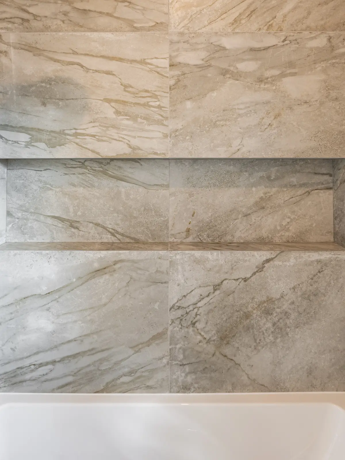 Room in a North York detached house renovation, with pale oak floors, white walls, and marble or warm wood millwork.