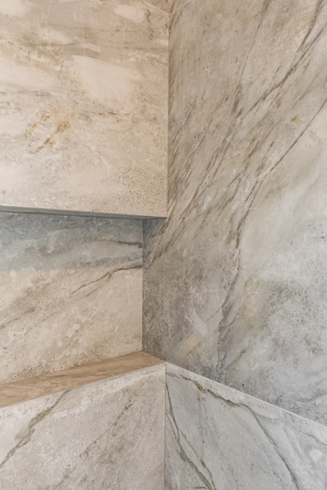 Room in a North York detached house renovation, with pale oak floors, white walls, and marble or warm wood millwork.