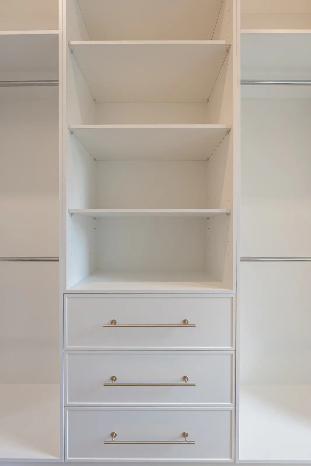 Room in a North York detached house renovation, with pale oak floors, white walls, and marble or warm wood millwork.