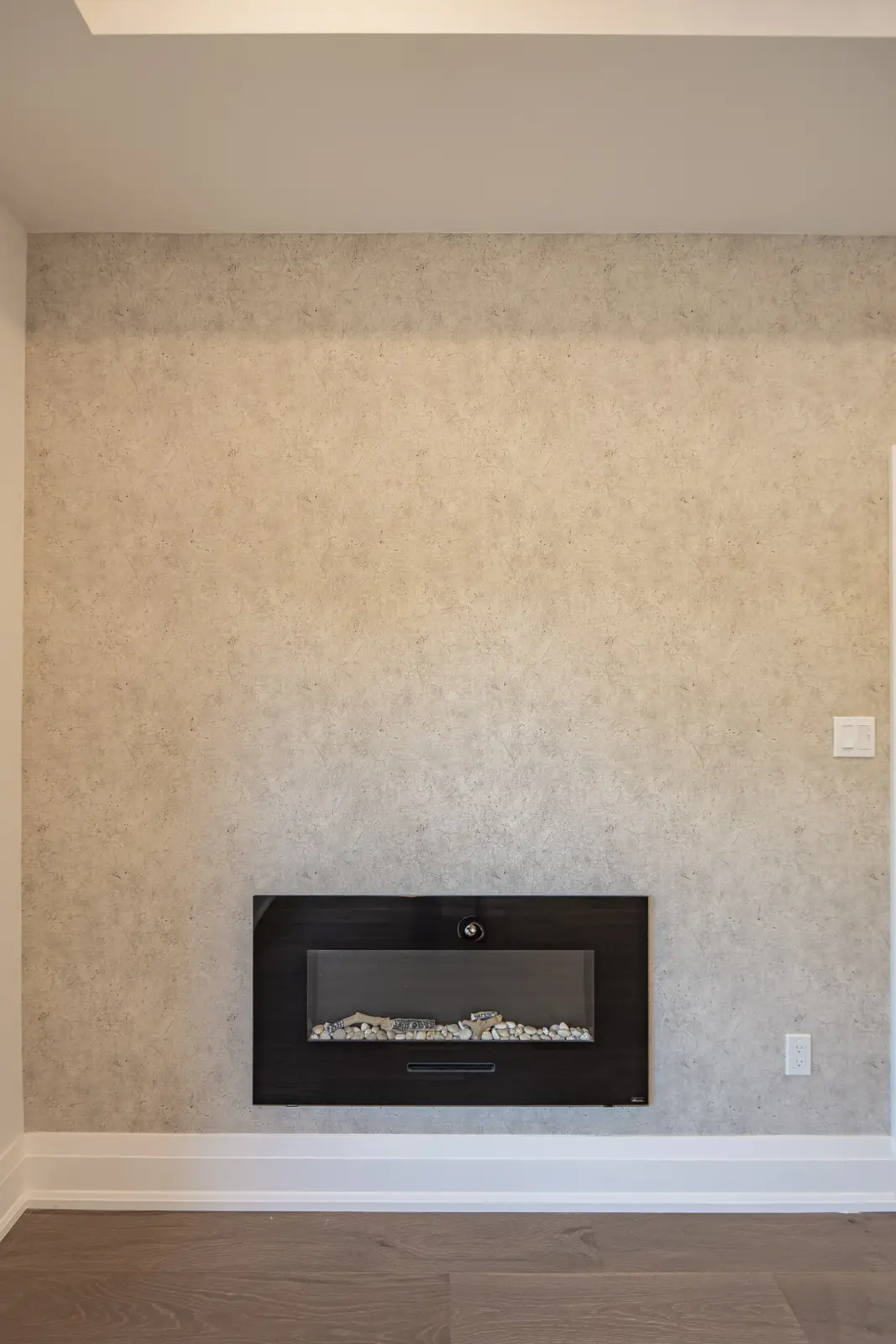 Room in a North York detached house renovation, with pale oak floors, white walls, and marble or warm wood millwork.