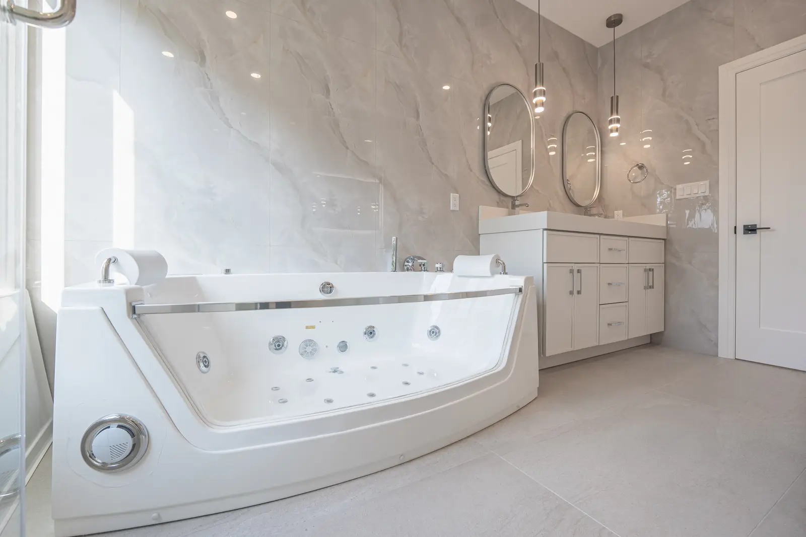 Room in a North York detached house renovation, with pale oak floors, white walls, and marble or warm wood millwork.