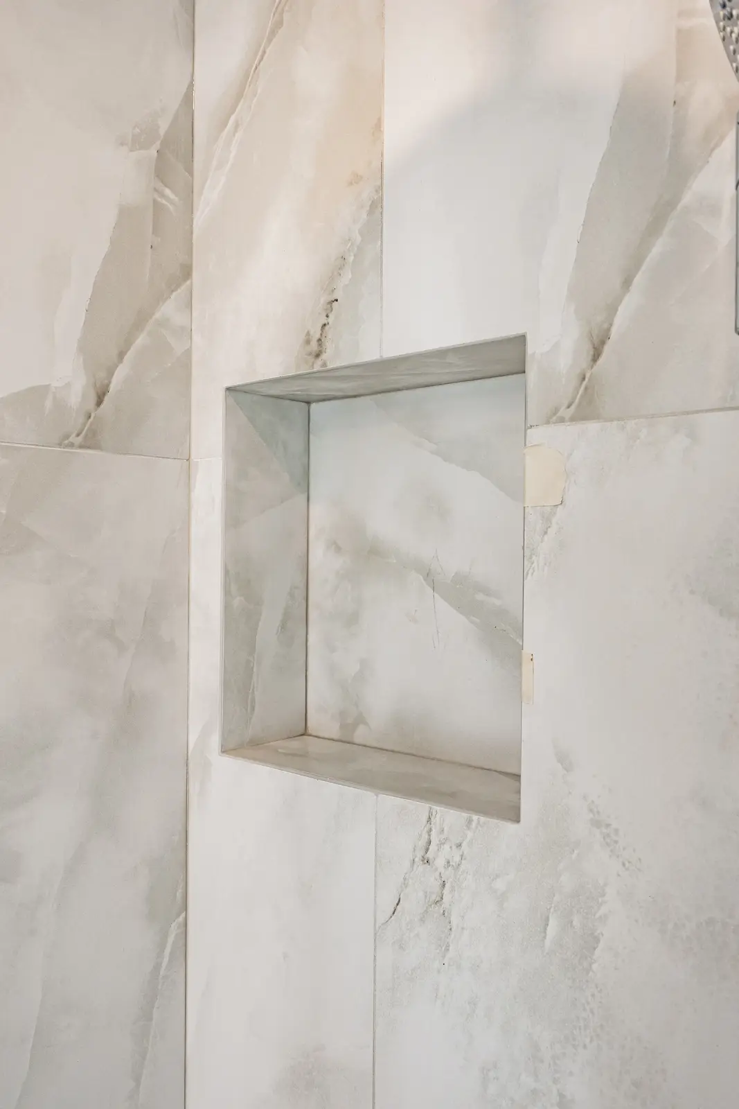 Room in a North York detached house renovation, with pale oak floors, white walls, and marble or warm wood millwork.