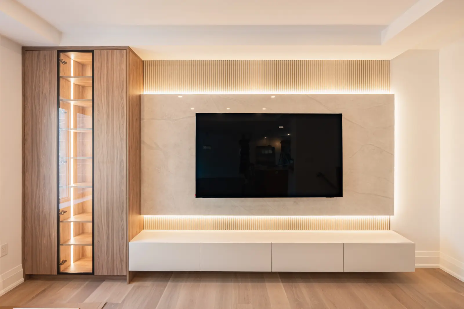 Room in a North York detached house renovation, with pale oak floors, white walls, and marble or warm wood millwork.
