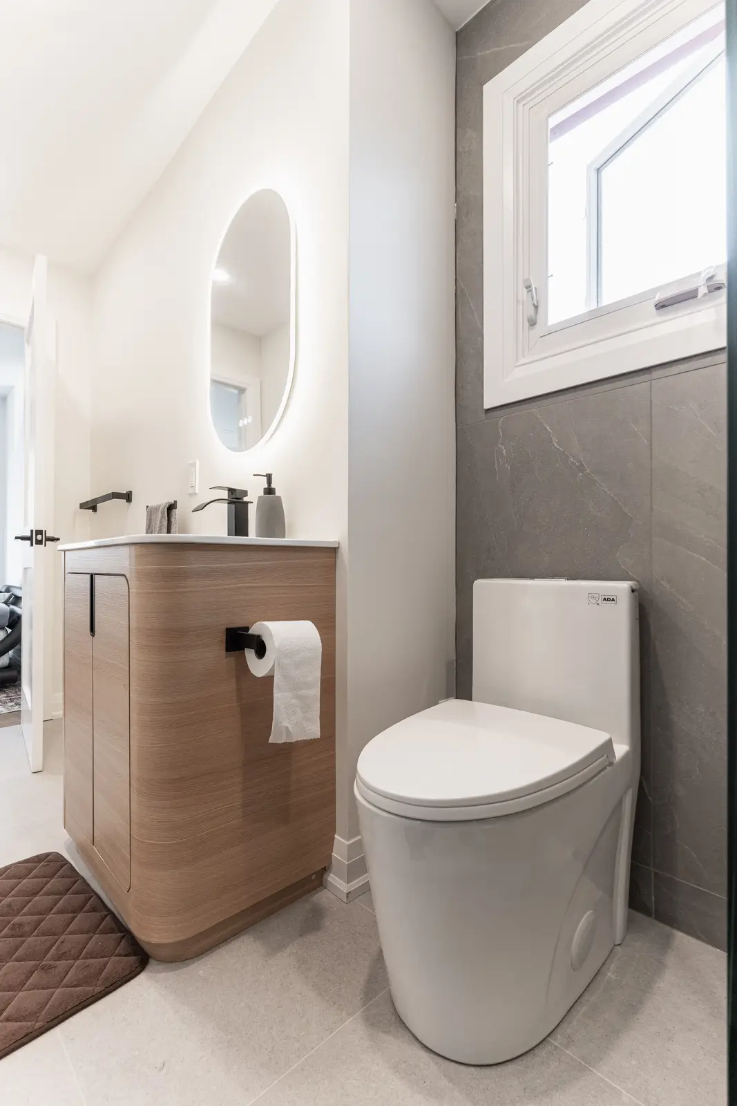 Interior of a Thornhill detached house renovation, with white cabinetry, light oak millwork, and a pale stone counter.