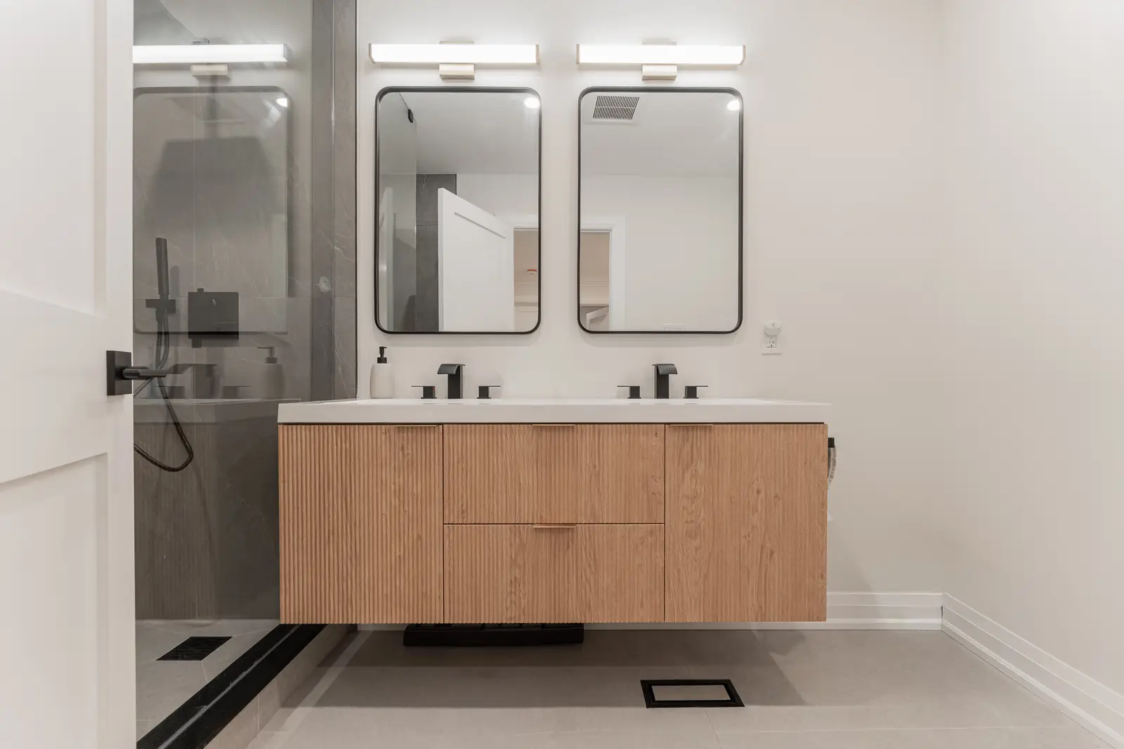 Interior of a Thornhill detached house renovation, with white cabinetry, light oak millwork, and a pale stone counter.