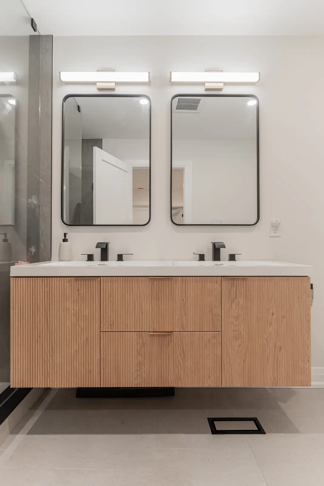 Interior of a Thornhill detached house renovation, with white cabinetry, light oak millwork, and a pale stone counter.
