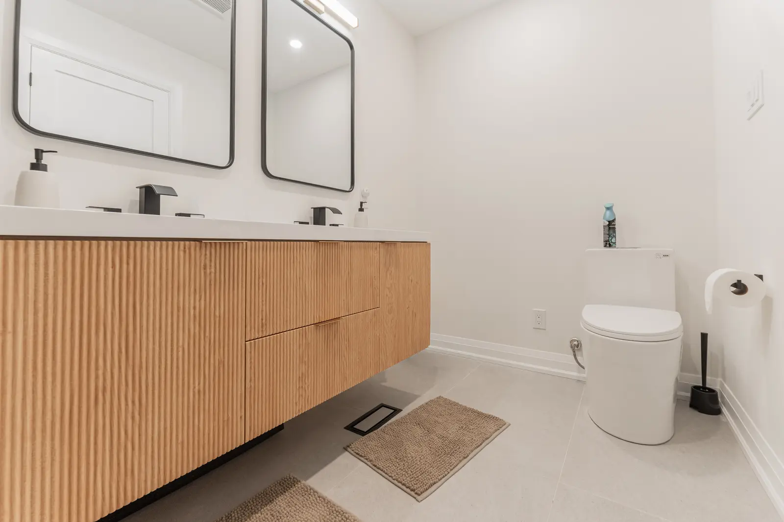 Interior of a Thornhill detached house renovation, with white cabinetry, light oak millwork, and a pale stone counter.