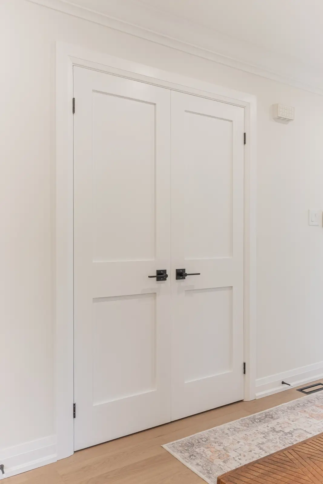 Interior of a Thornhill detached house renovation, with white cabinetry, light oak millwork, and a pale stone counter.