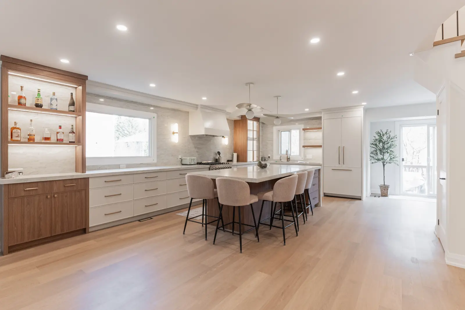 Interior of a Thornhill detached house renovation, with white cabinetry, light oak millwork, and a pale stone counter.