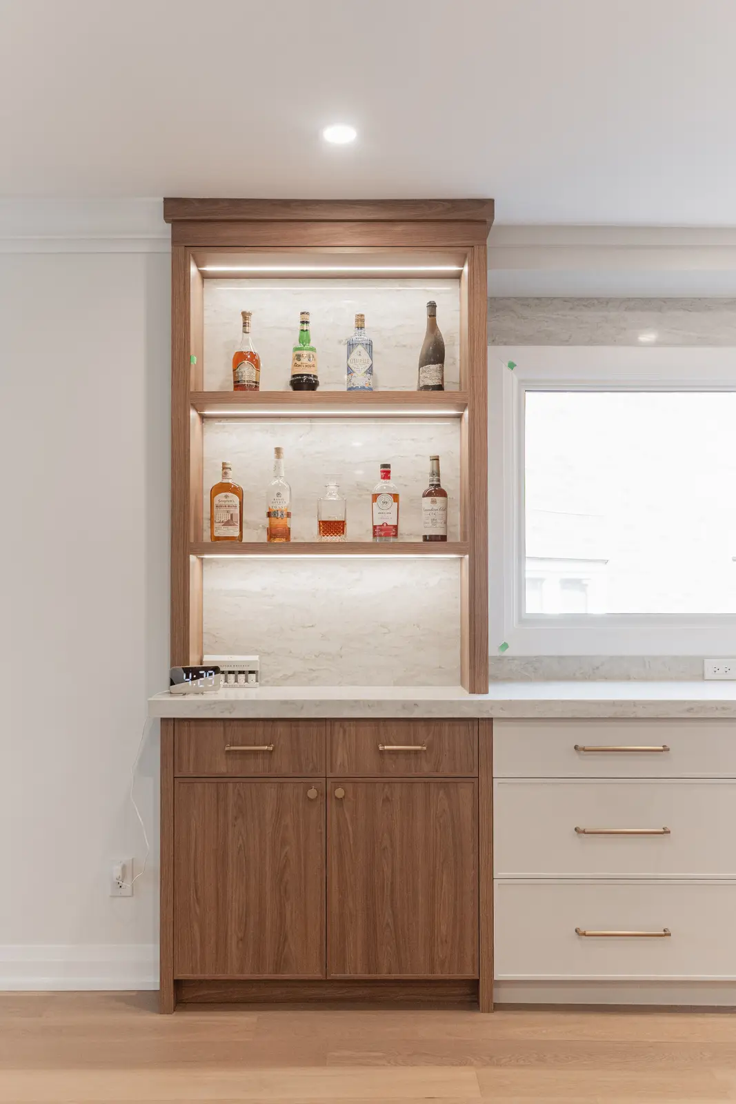 Interior of a Thornhill detached house renovation, with white cabinetry, light oak millwork, and a pale stone counter.