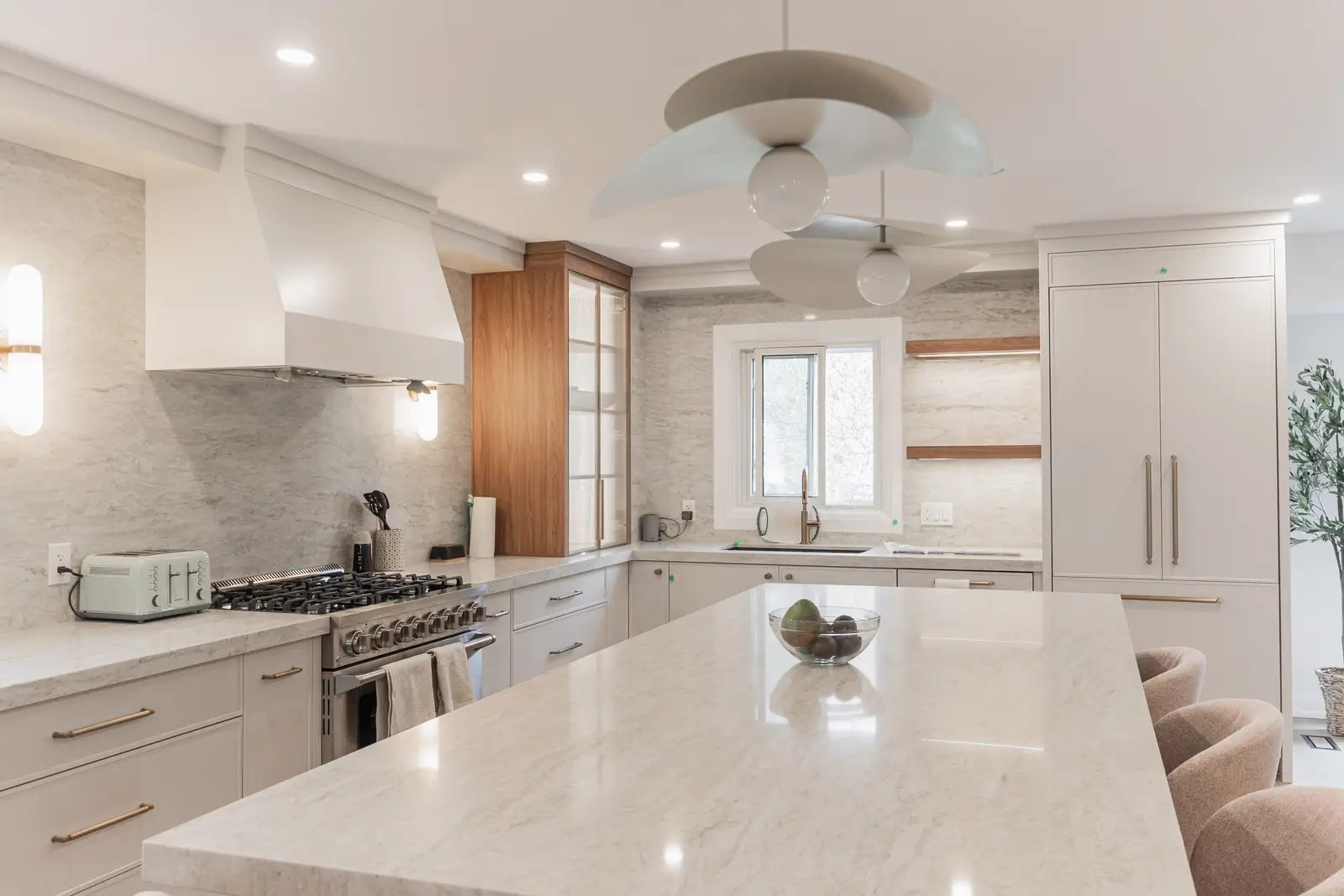 Interior of a Thornhill detached house renovation, with white cabinetry, light oak millwork, and a pale stone counter.