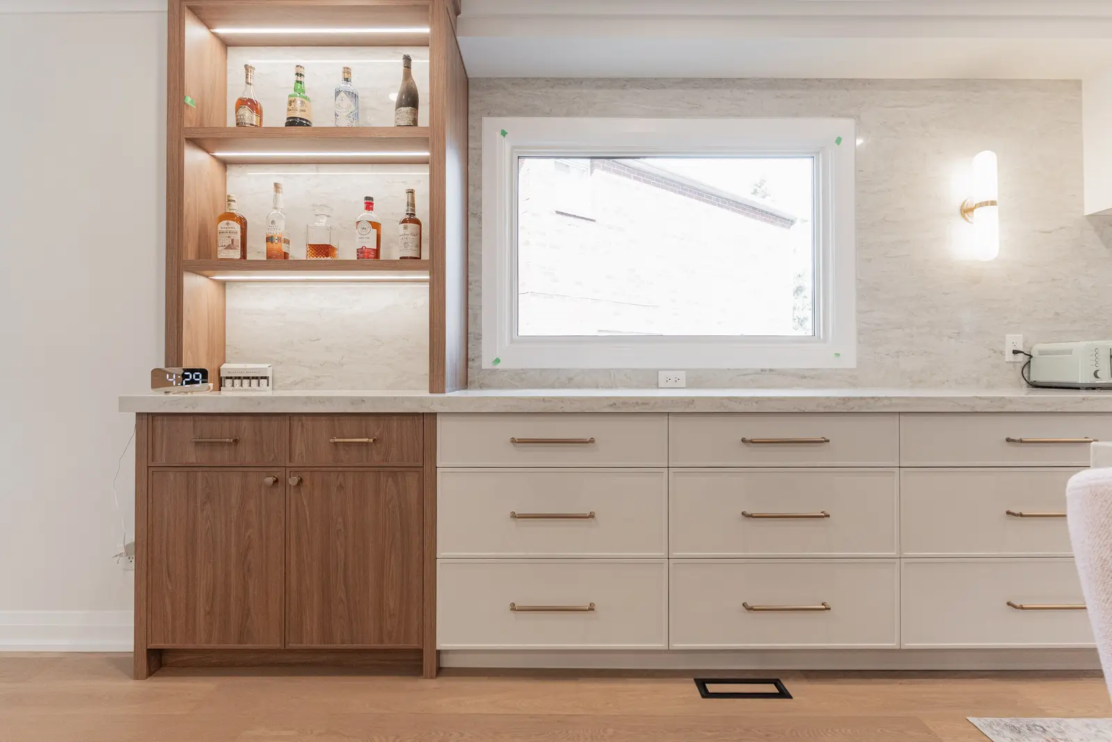 Interior of a Thornhill detached house renovation, with white cabinetry, light oak millwork, and a pale stone counter.