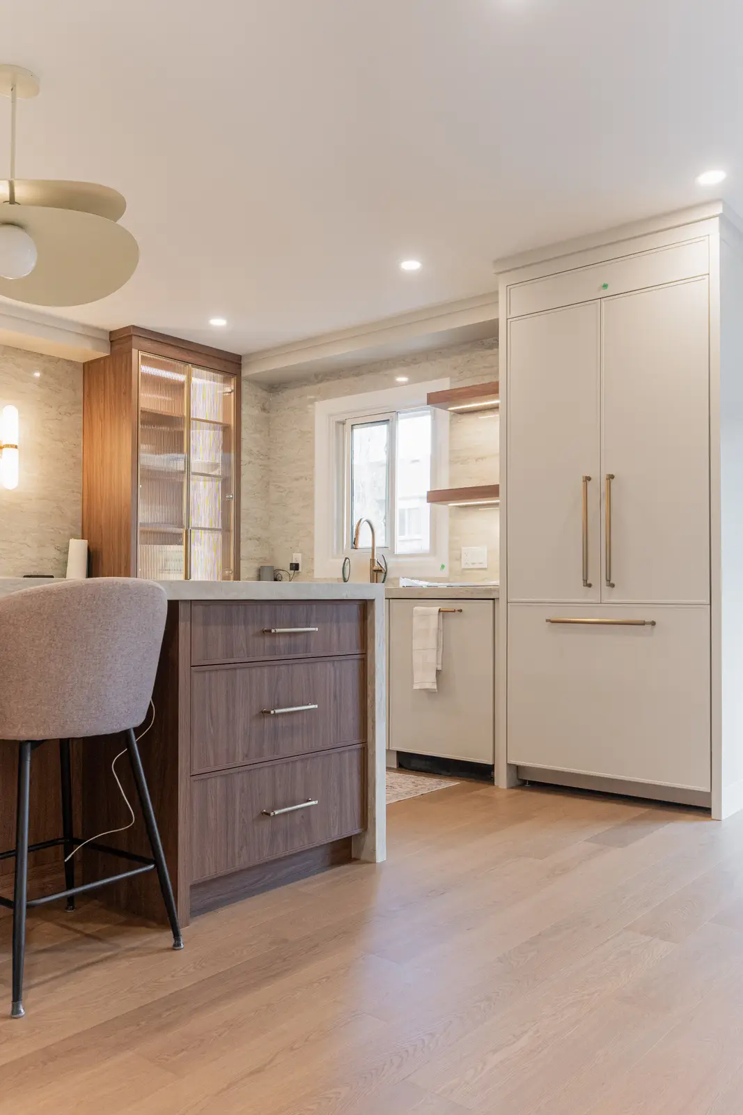 Interior of a Thornhill detached house renovation, with white cabinetry, light oak millwork, and a pale stone counter.