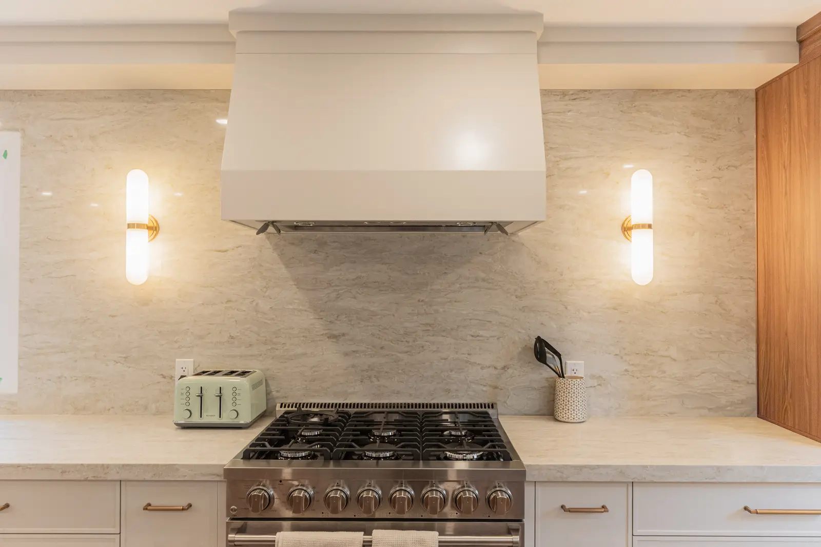 Interior of a Thornhill detached house renovation, with white cabinetry, light oak millwork, and a pale stone counter.