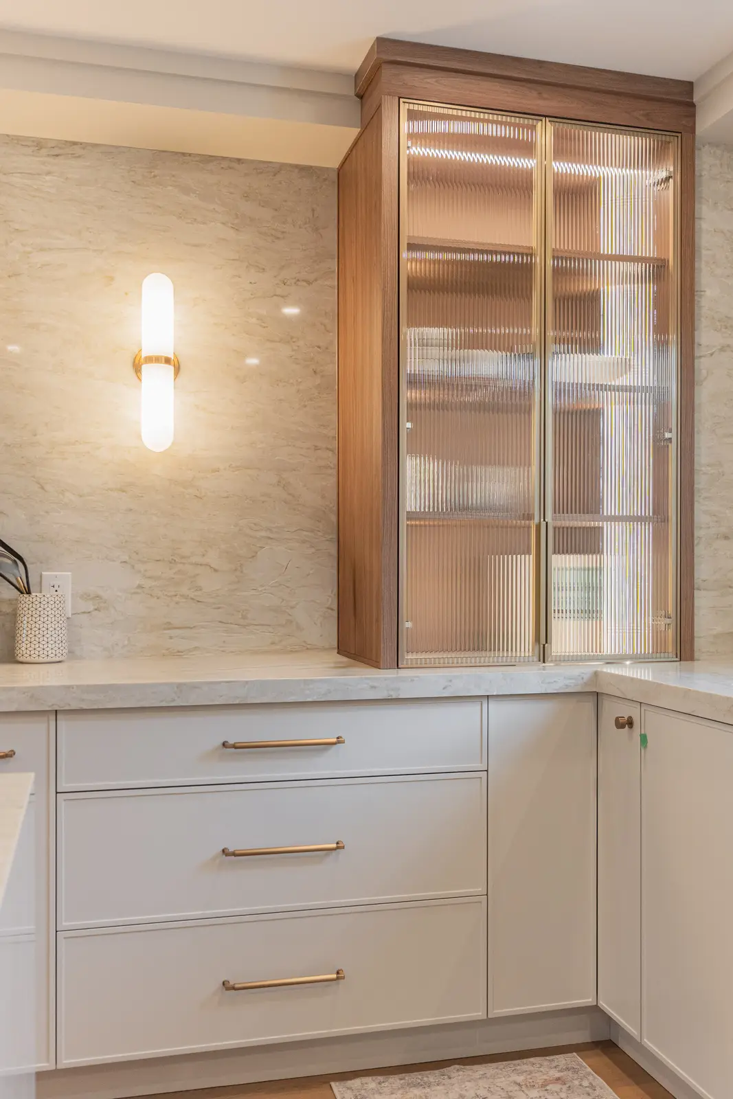 Interior of a Thornhill detached house renovation, with white cabinetry, light oak millwork, and a pale stone counter.