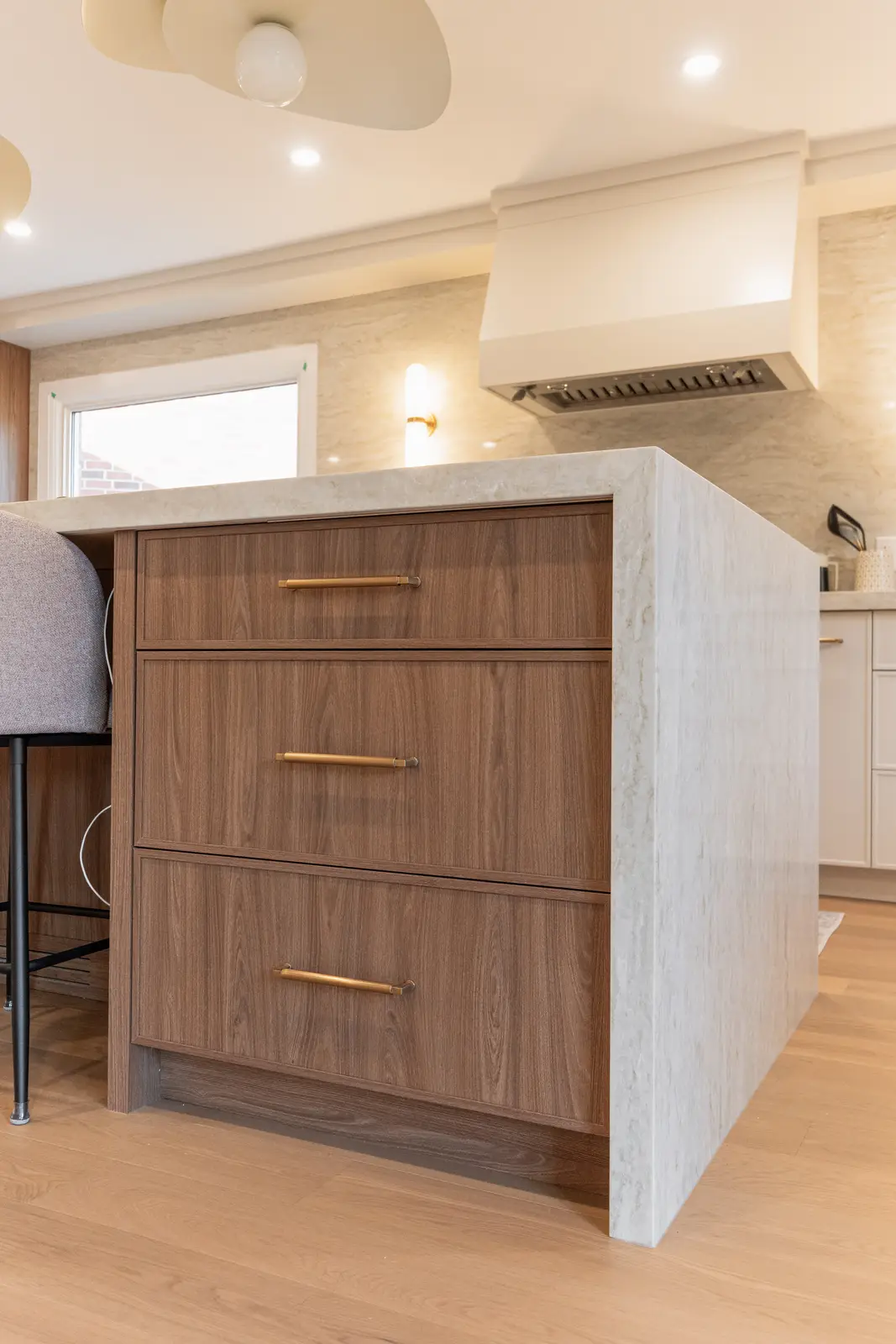 Interior of a Thornhill detached house renovation, with white cabinetry, light oak millwork, and a pale stone counter.