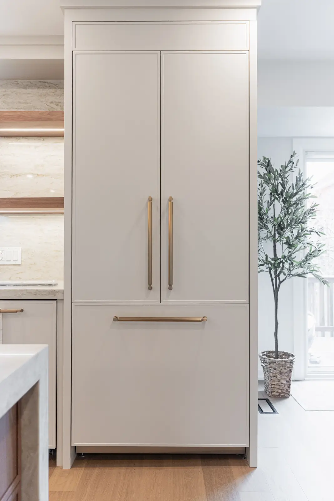 Interior of a Thornhill detached house renovation, with white cabinetry, light oak millwork, and a pale stone counter.