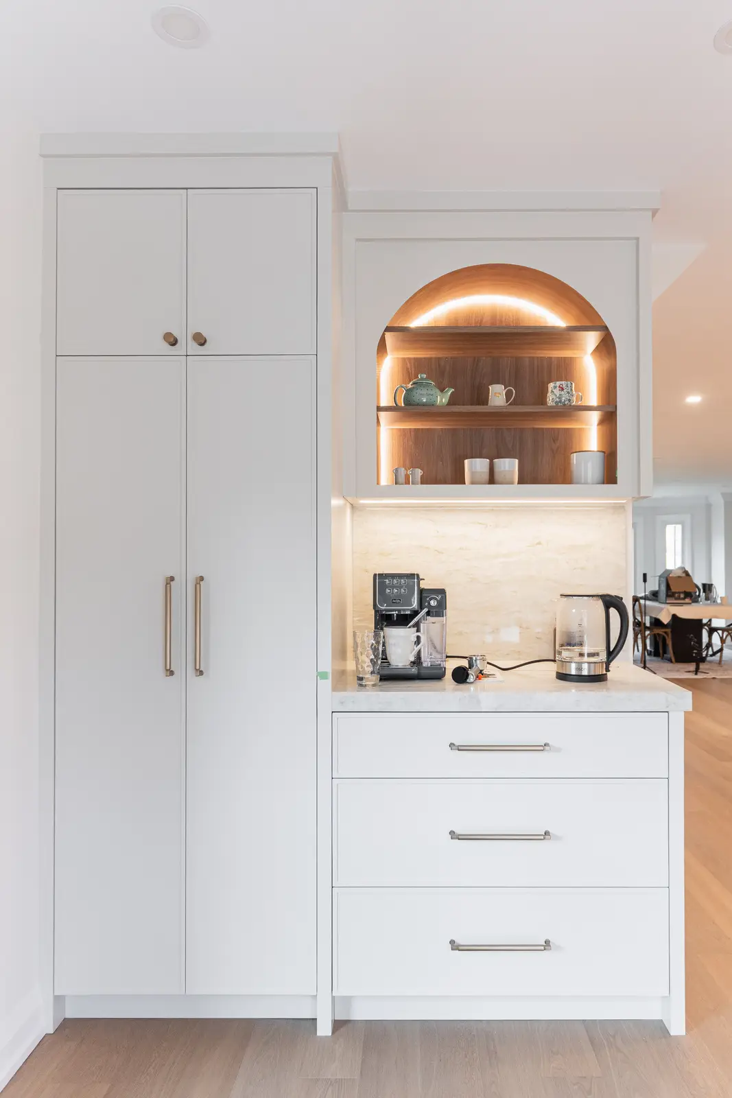 Interior of a Thornhill detached house renovation, with white cabinetry, light oak millwork, and a pale stone counter.