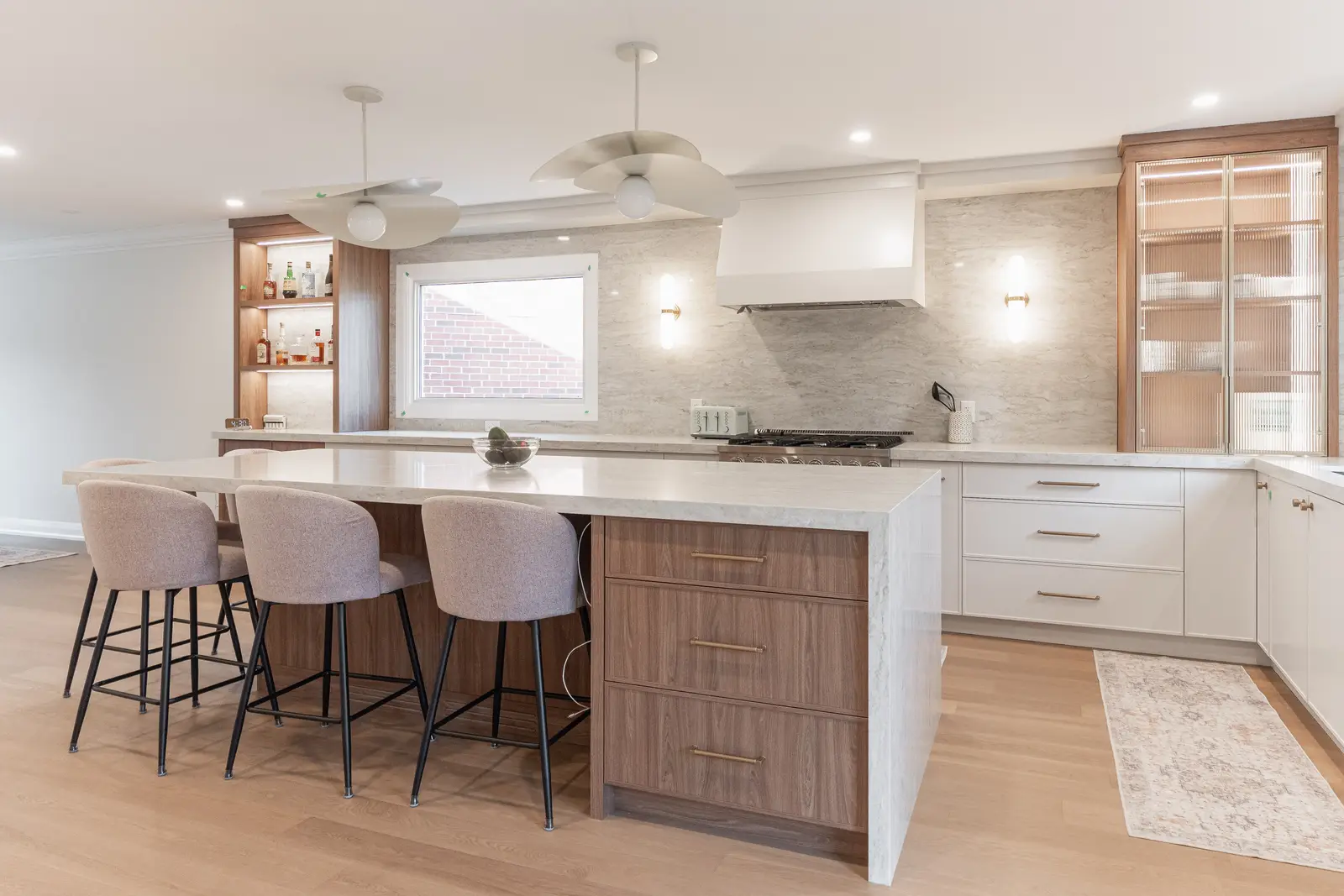 Interior of a Thornhill detached house renovation, with white cabinetry, light oak millwork, and a pale stone counter.