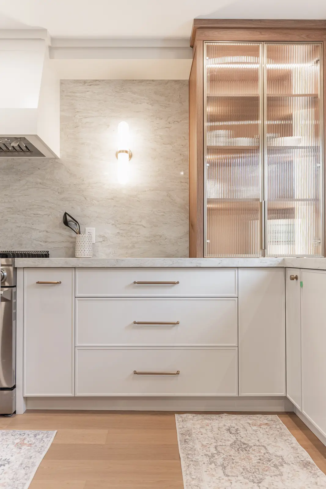 Interior of a Thornhill detached house renovation, with white cabinetry, light oak millwork, and a pale stone counter.